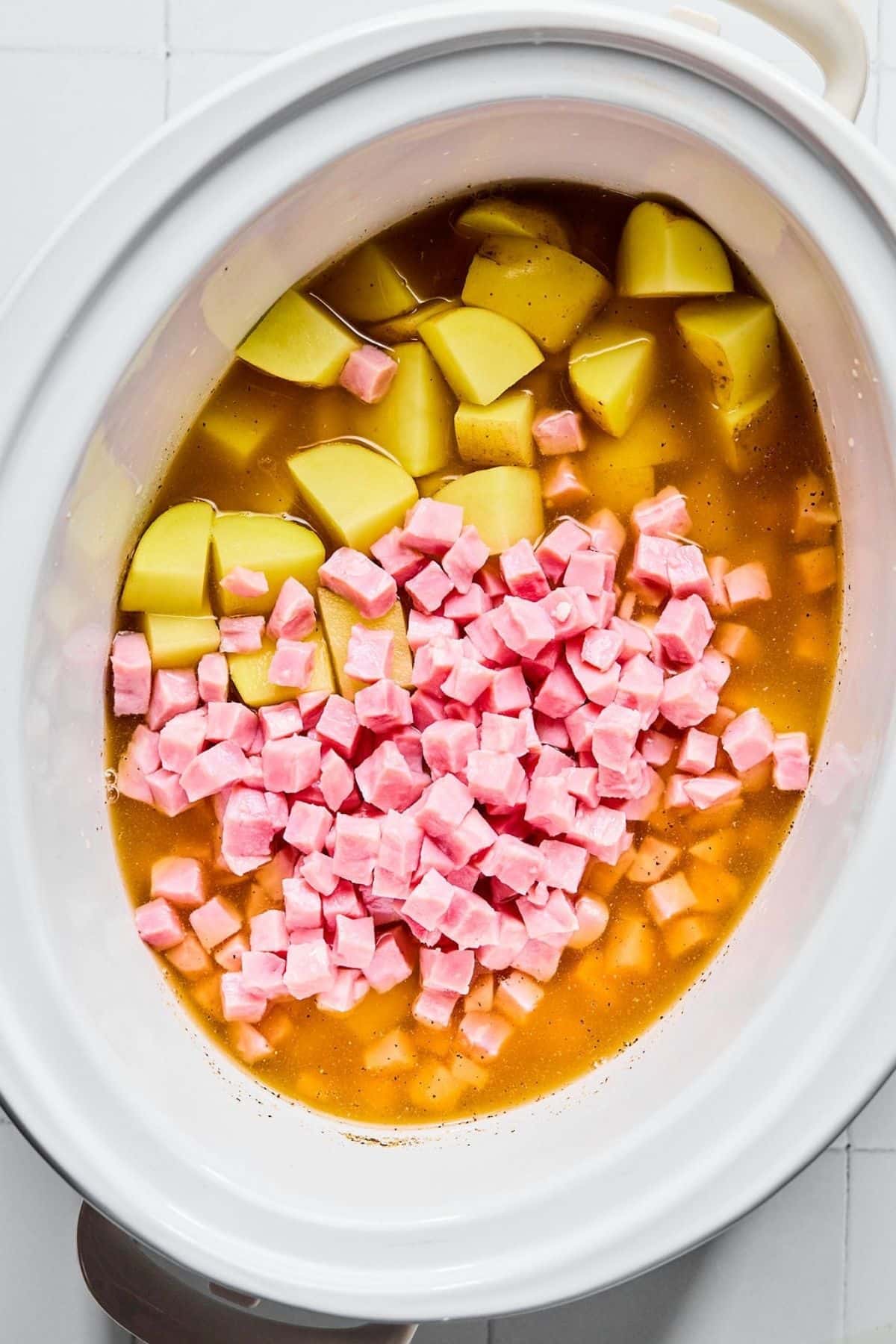 Ham and potatoes put into the broth.
