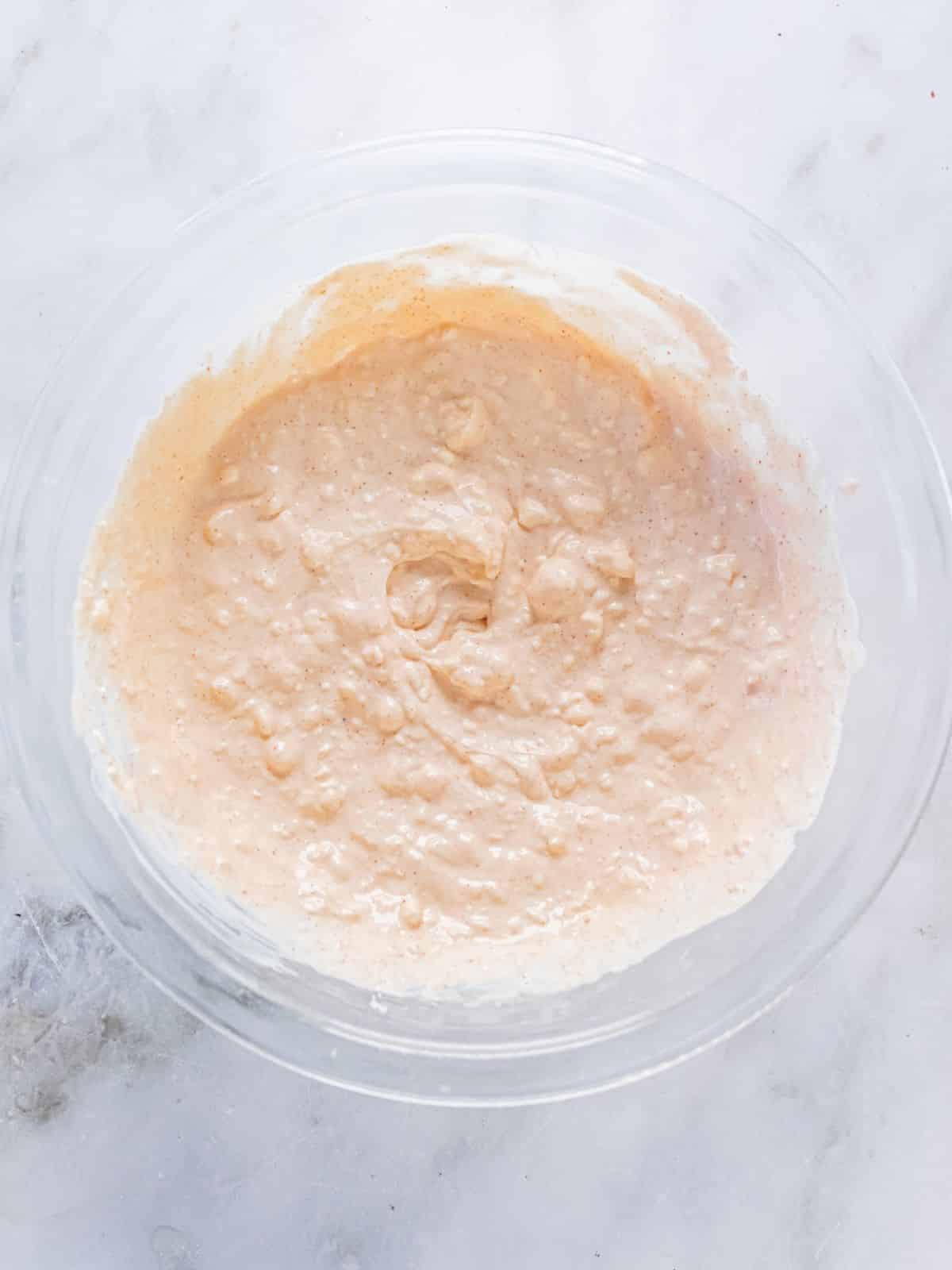 Cream cheese mixture for warm crab dip in a bowl.