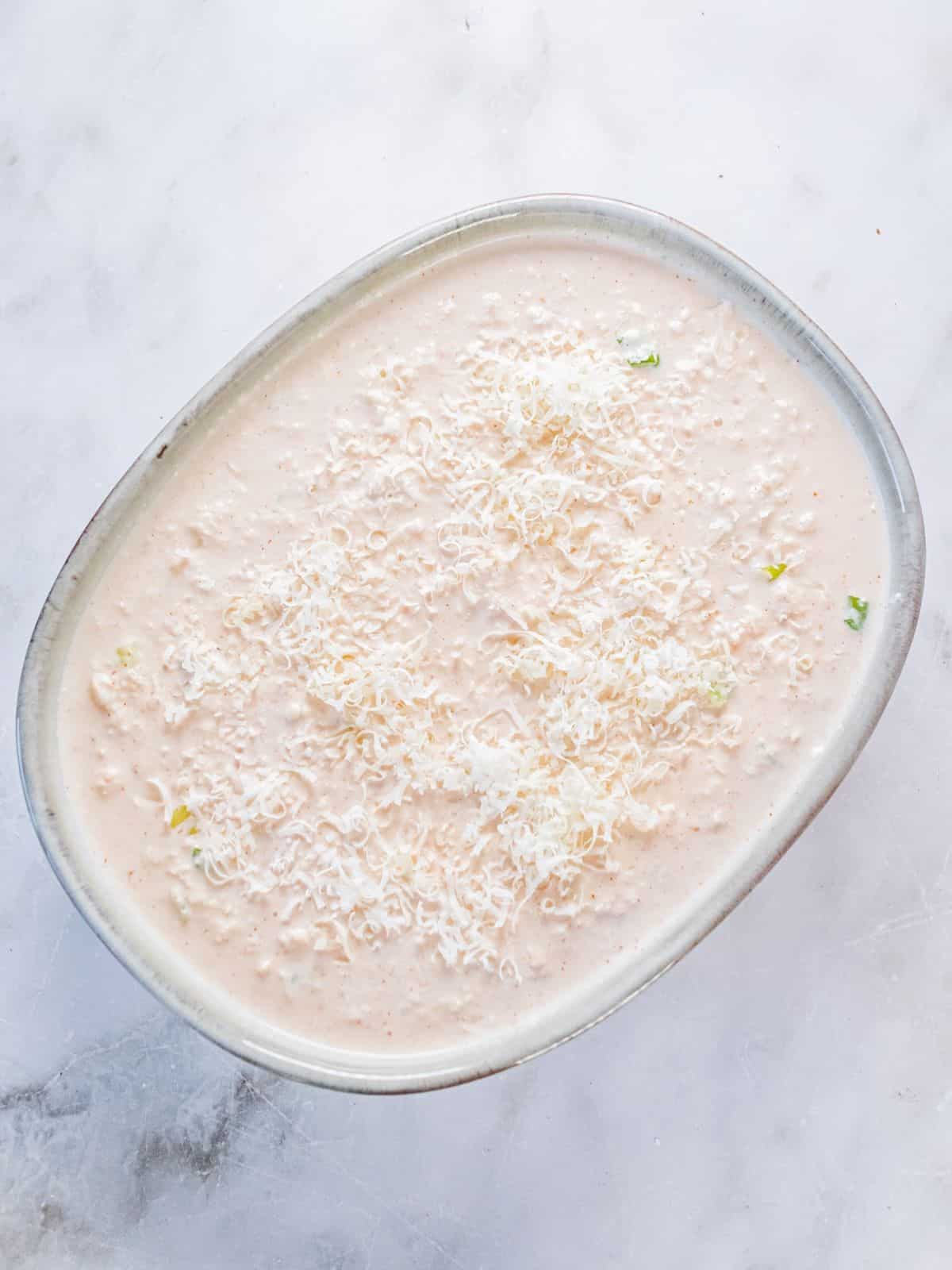Cream cheese crab dip transferred to a baking dish.