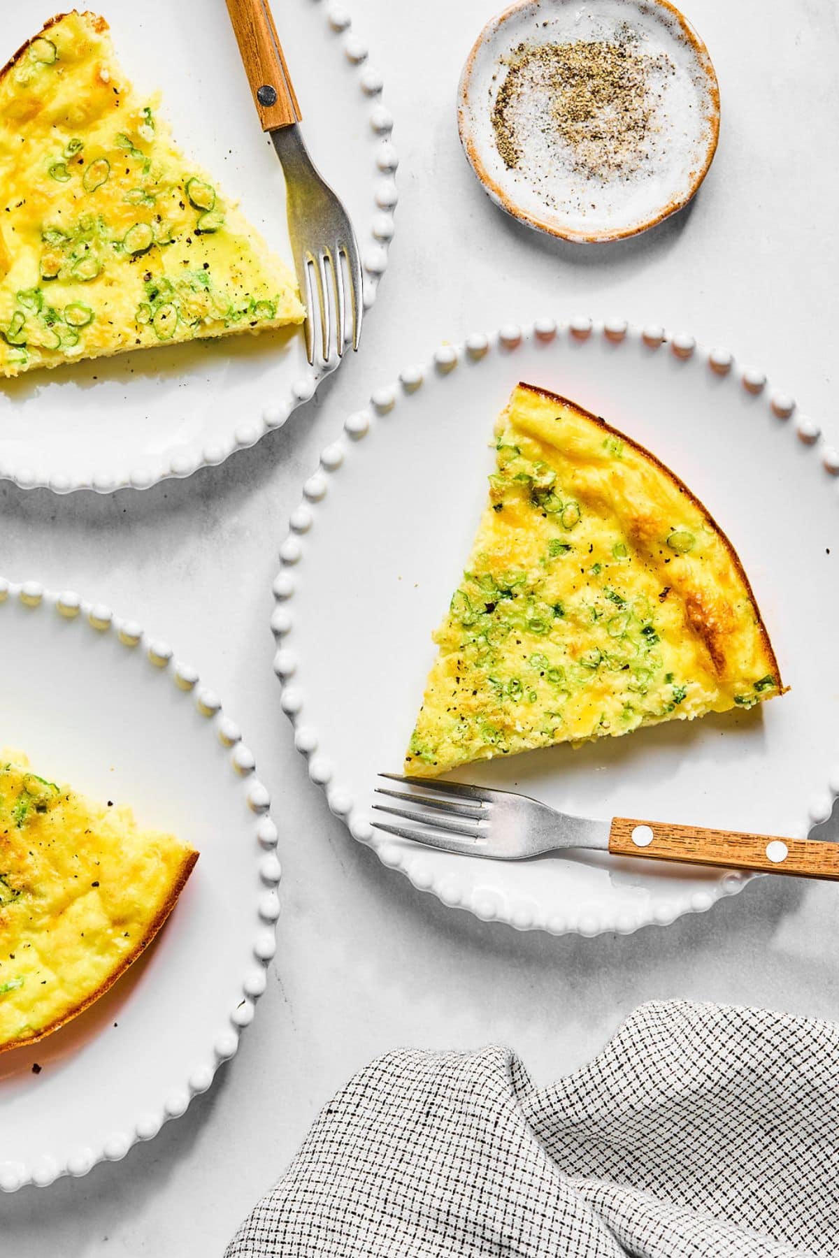 A quiche without crust on a plate.