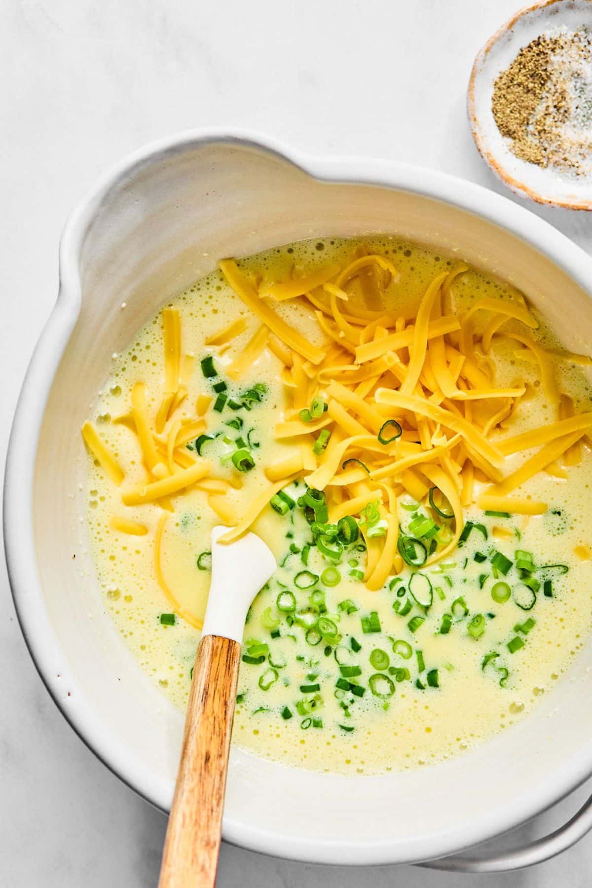 Cheese and scallions added to the egg mixture.