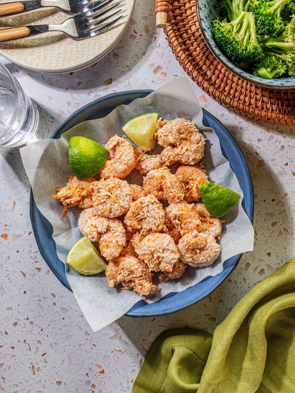 Baked coconut shrimp with limes on the side.
