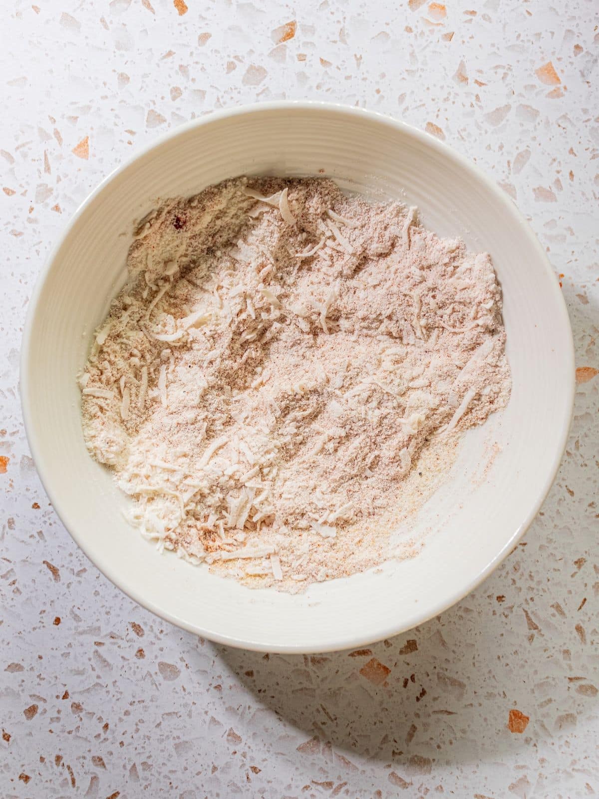 Coconut flour and flakes in a bowl.