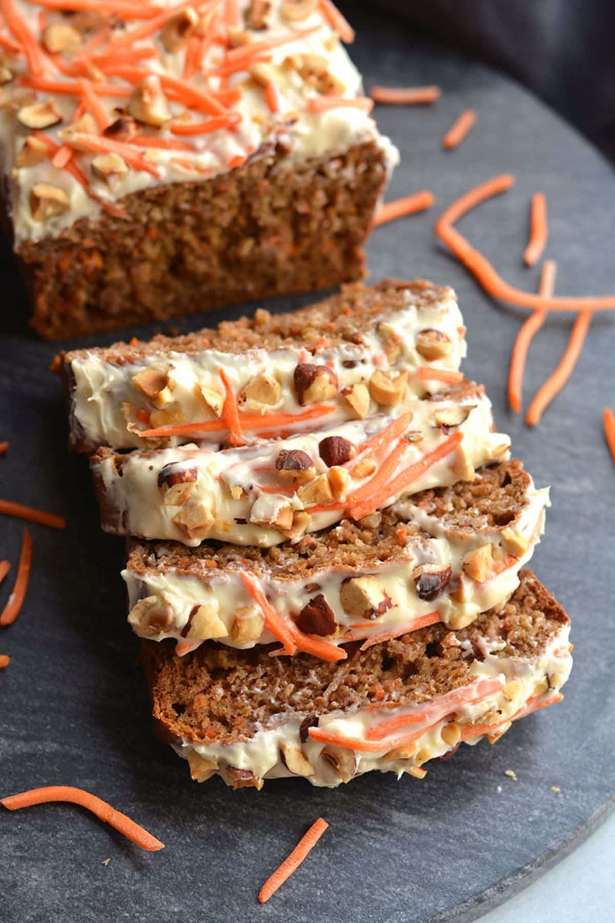 Banana carrot bread sliced up with a few slices leaning over.