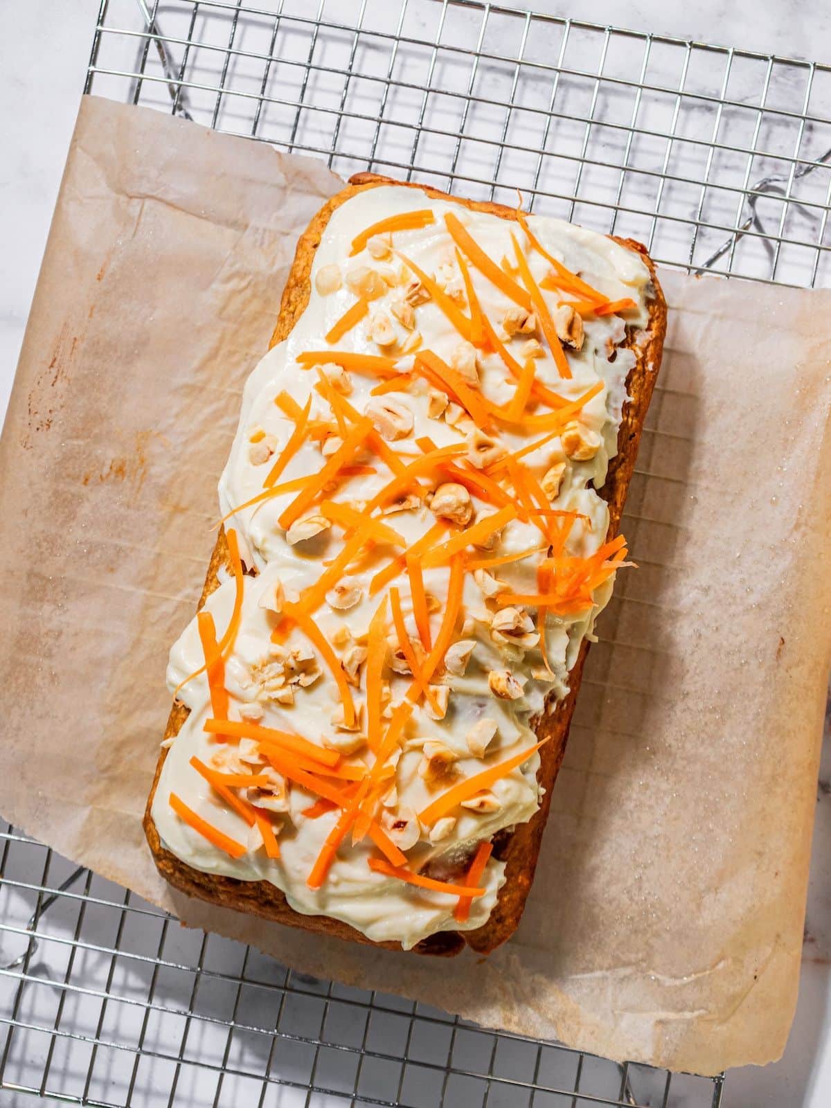 Carrots and nuts put on the top of the cake.