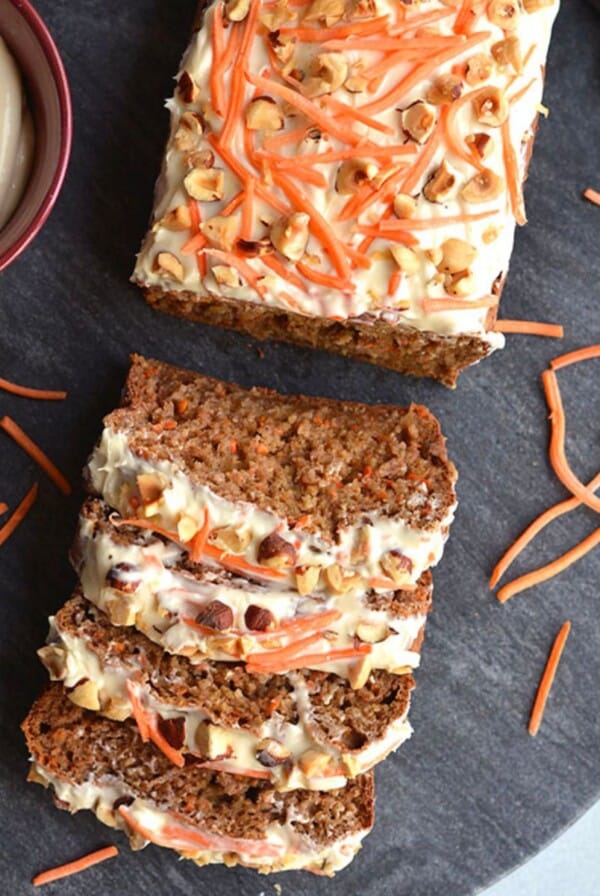 A banana carrot bread with 4 slices laid on the side.
