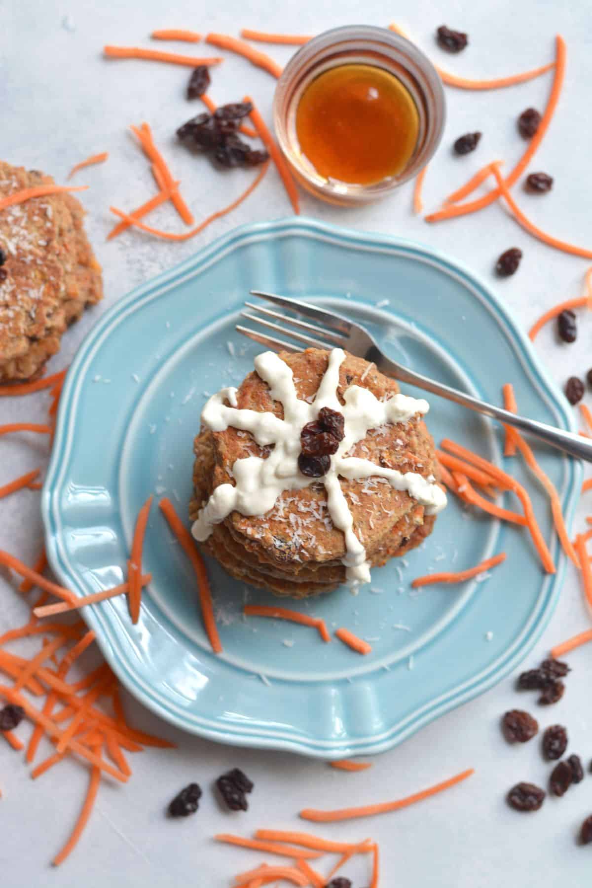 A stack of carrot cake pancakes on a blue plate.