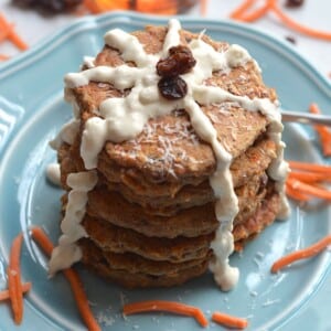 Carrot cake pancakes with icing drizzled down the sides.