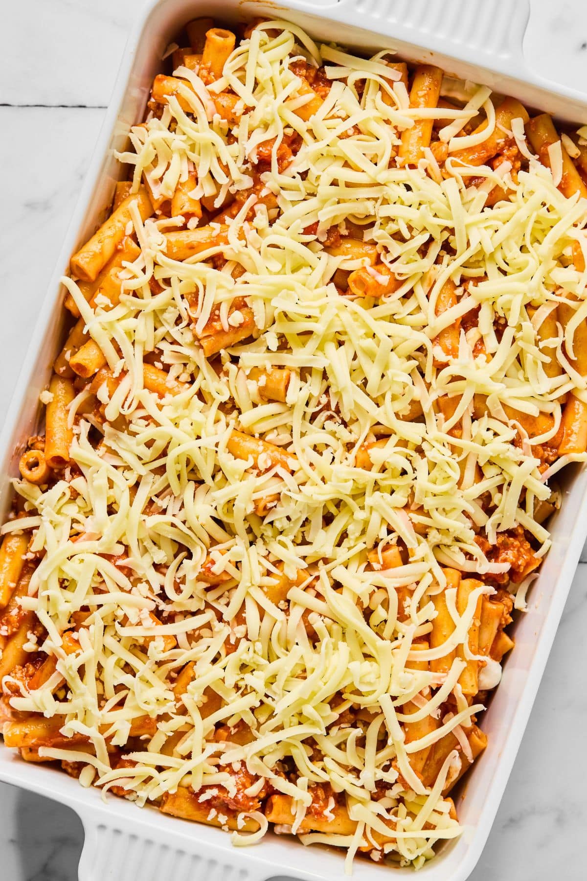 Mozzarella cheese added to the top of the ziti.