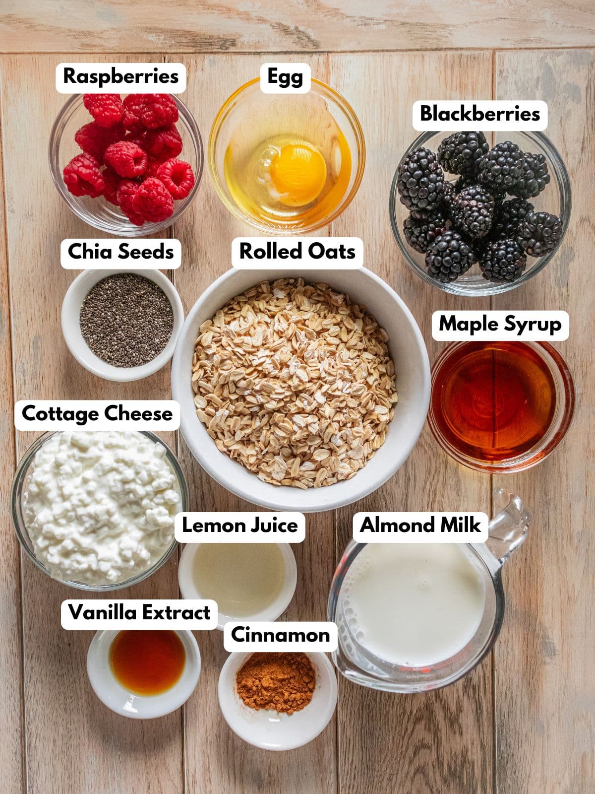 Ingredients to make these breakfast bars with cottage cheese in bowls on a table.