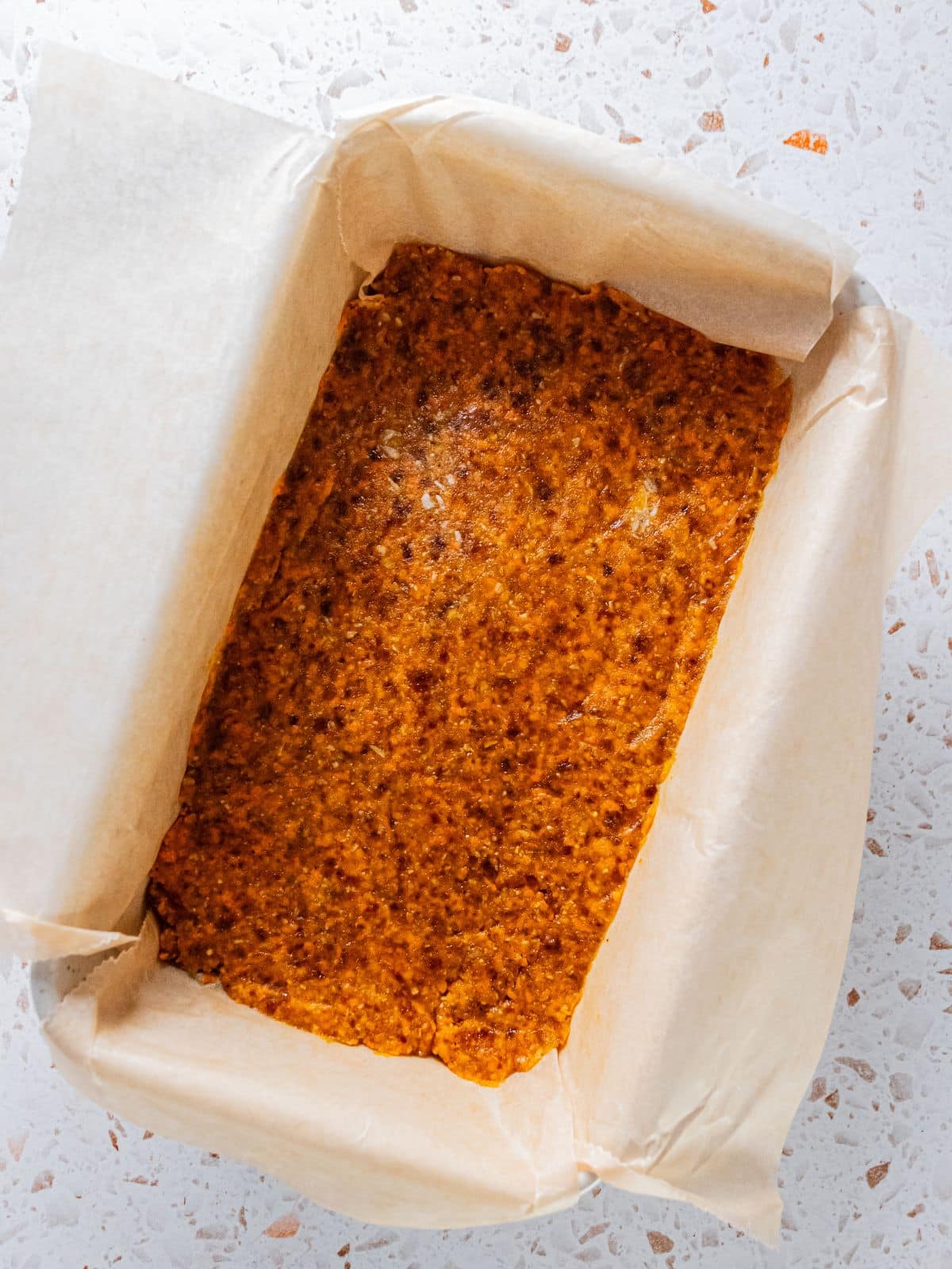 The cake mixture added to the loaf pan.