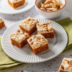 Four pieces of gluten free carrot cake on a plate.