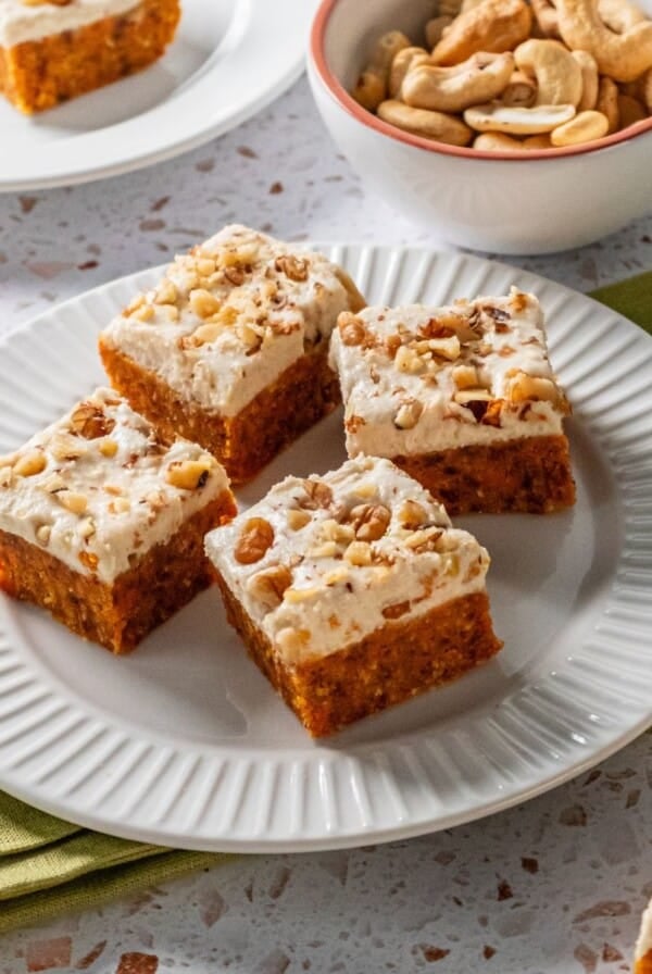 Four pieces of gluten free carrot cake on a plate.