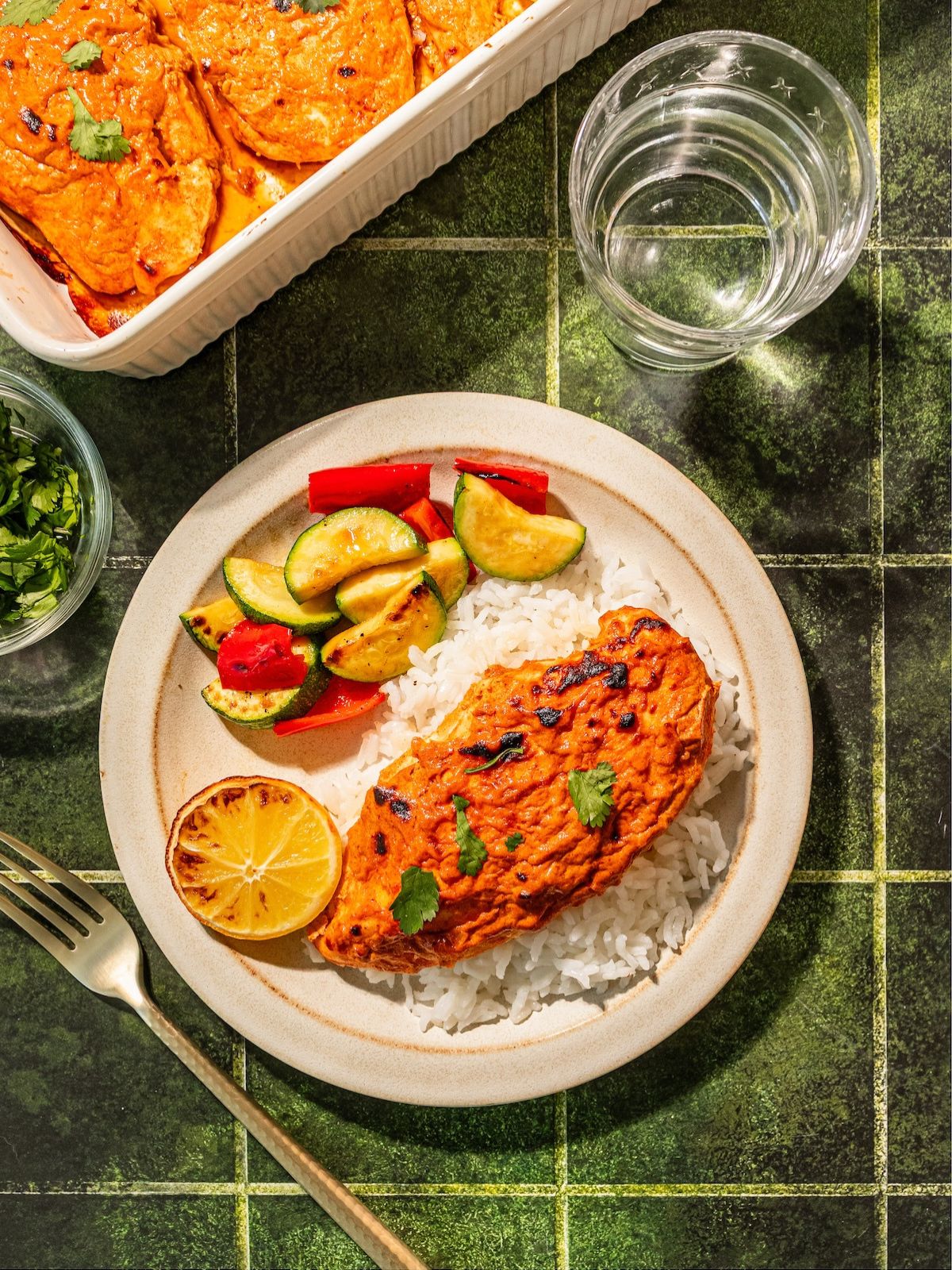 A plate with veggies, rice and greek yogurt chicken.