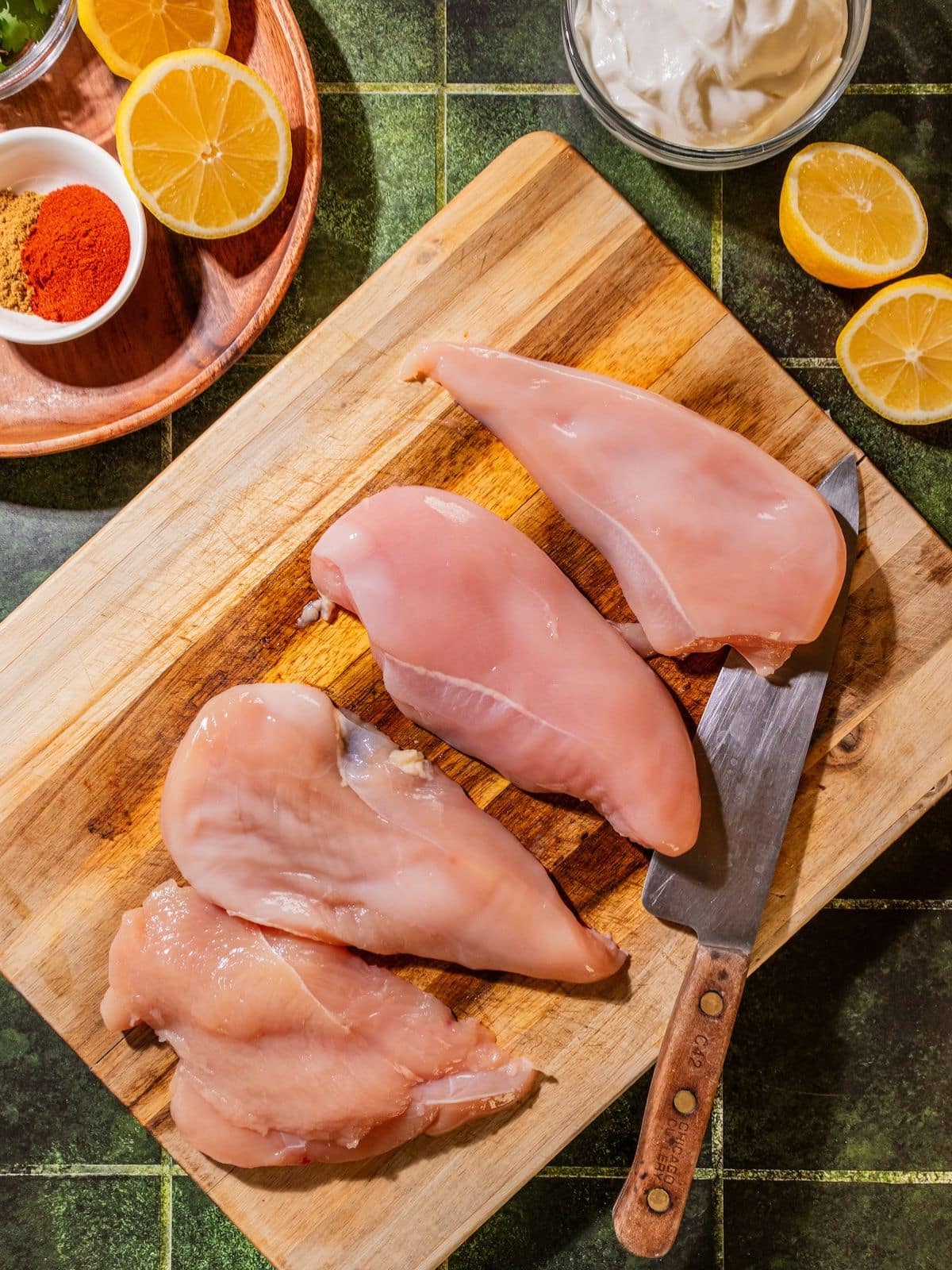 Chicken breast being sliced in the middle.