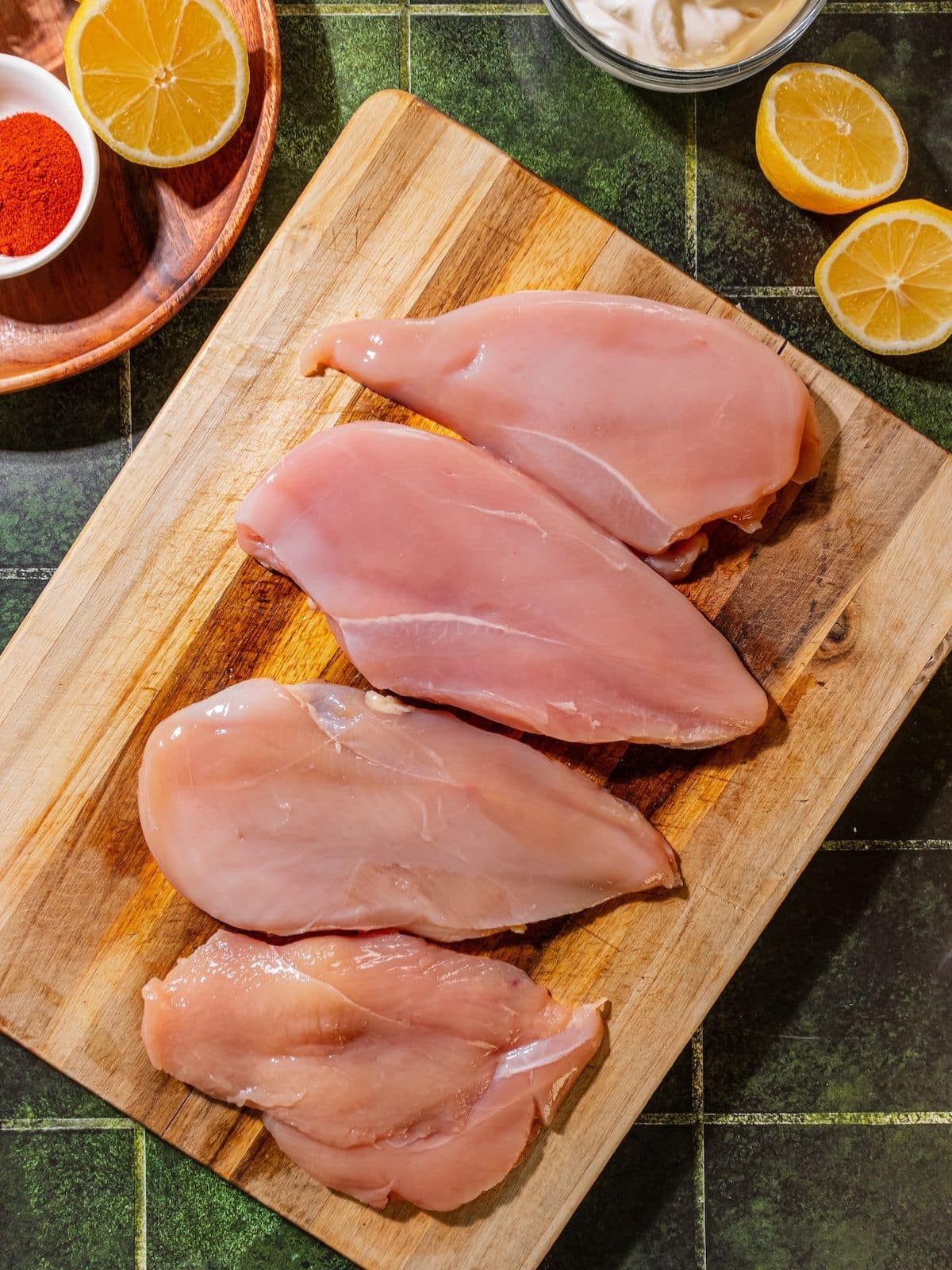 Chicken halves on a cutting board.