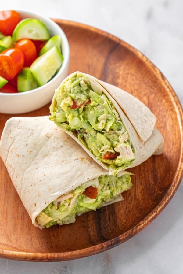 Guacamole chicken salad in a wrap with the side of veggies.