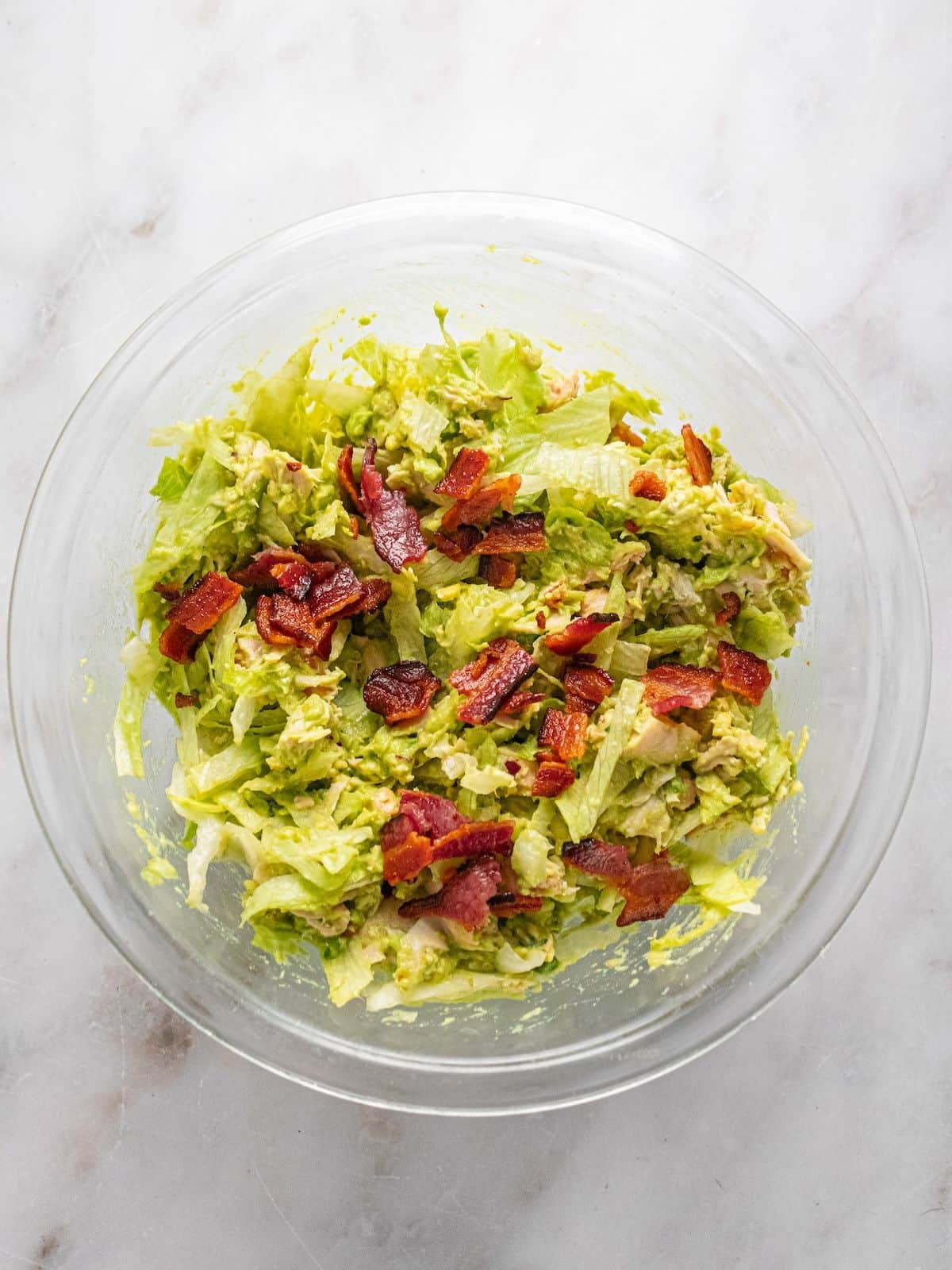 Bacon added to the top of the salad.