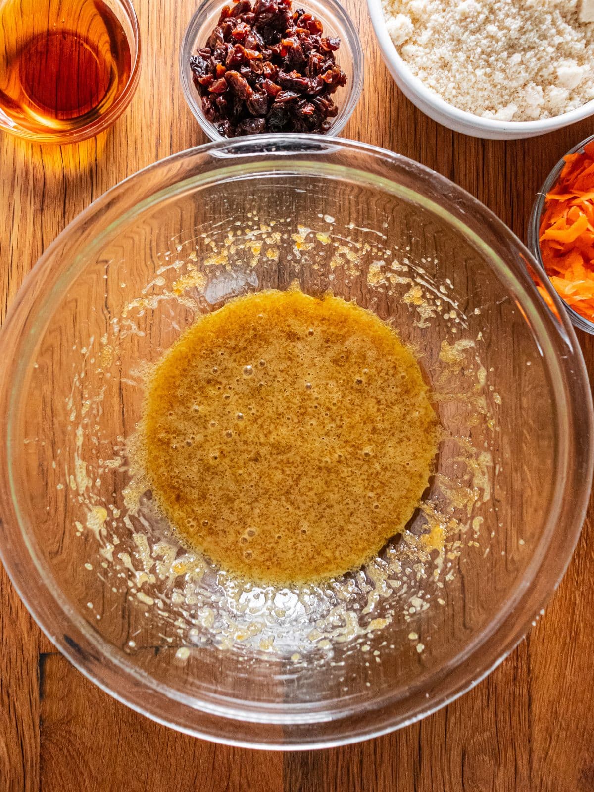 Oil, sugar, eggs and vanilla extract beaten in a large mixing bowl.