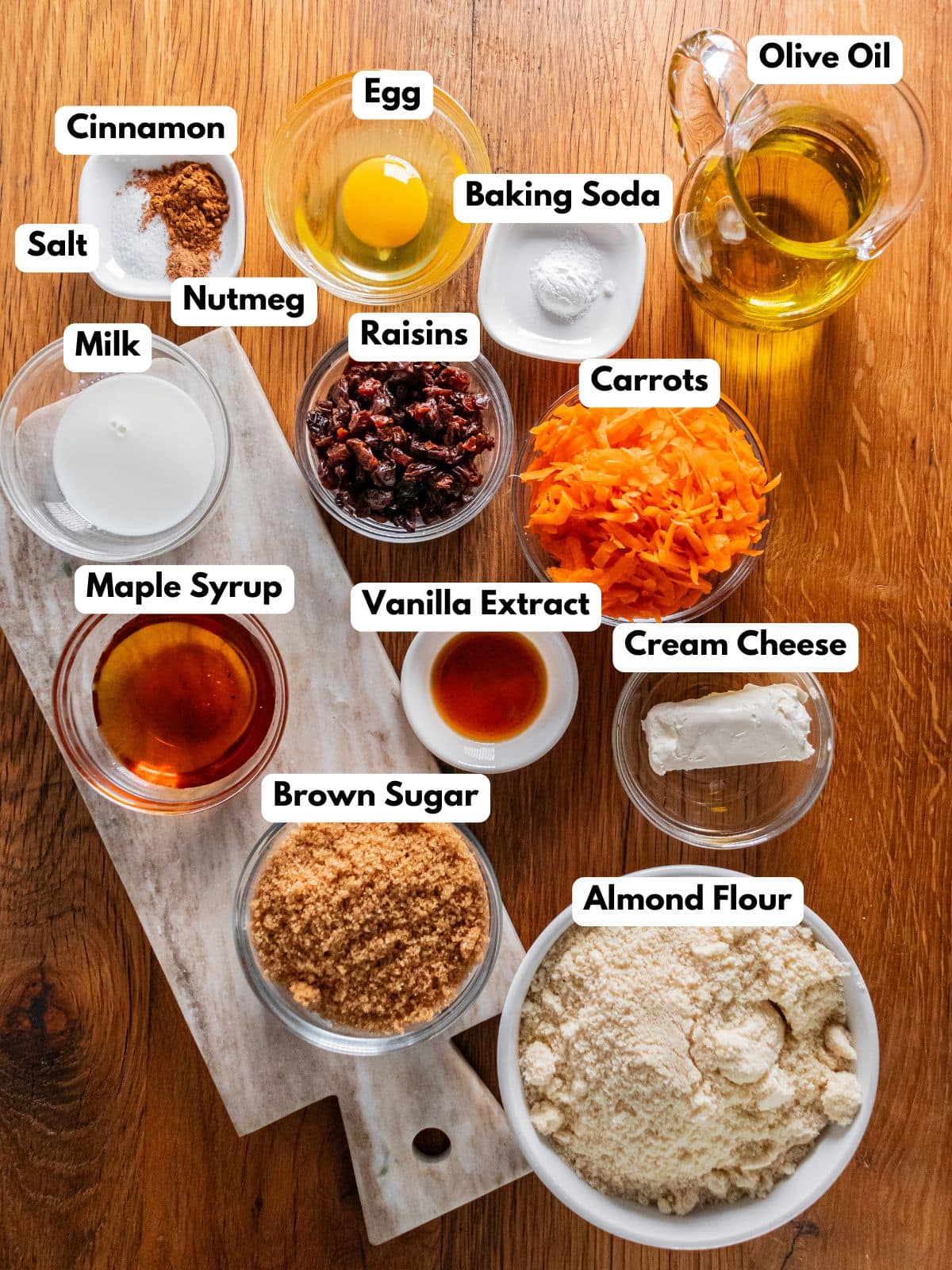 Ingredients to make these healthy carrot cookies in bowls on a table.