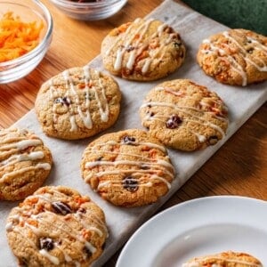 Healthy carrot cake cookies with raisins in them on a baking tray.