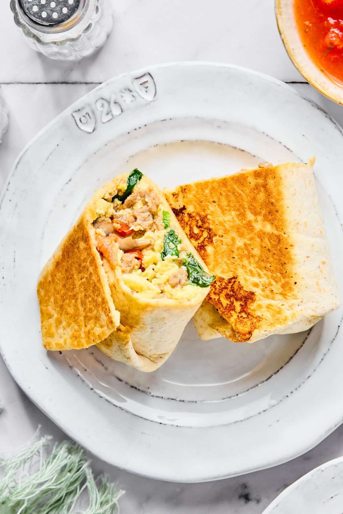 High protein breakfast burrito on a plate.