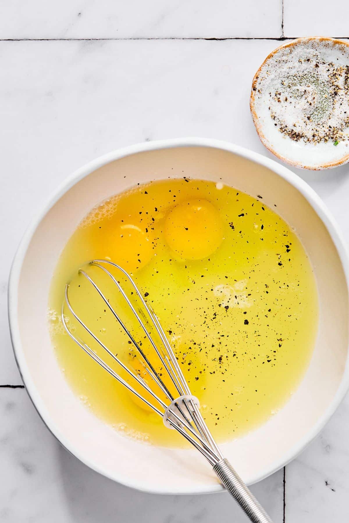Eggs and spices in a bowl.