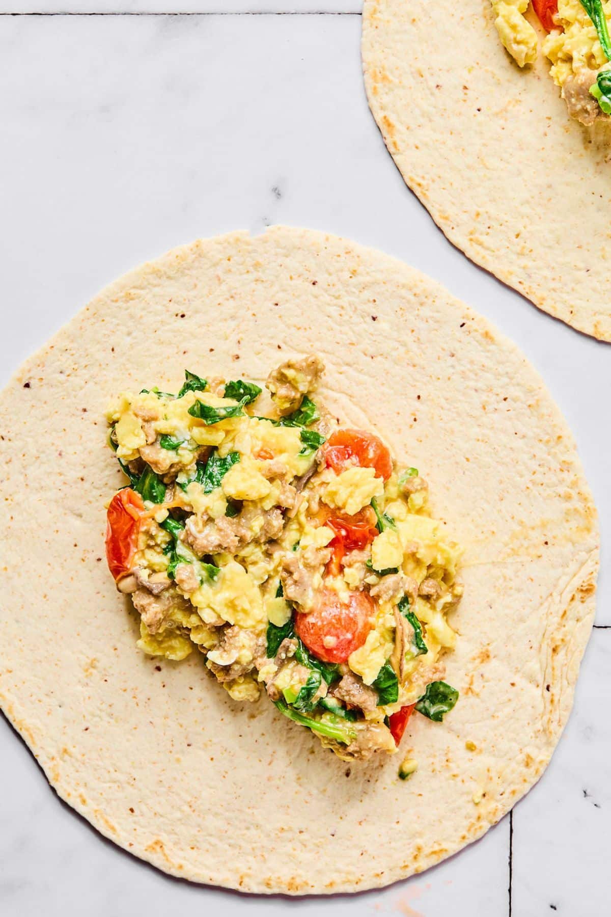 Egg mixture added to a tortilla.