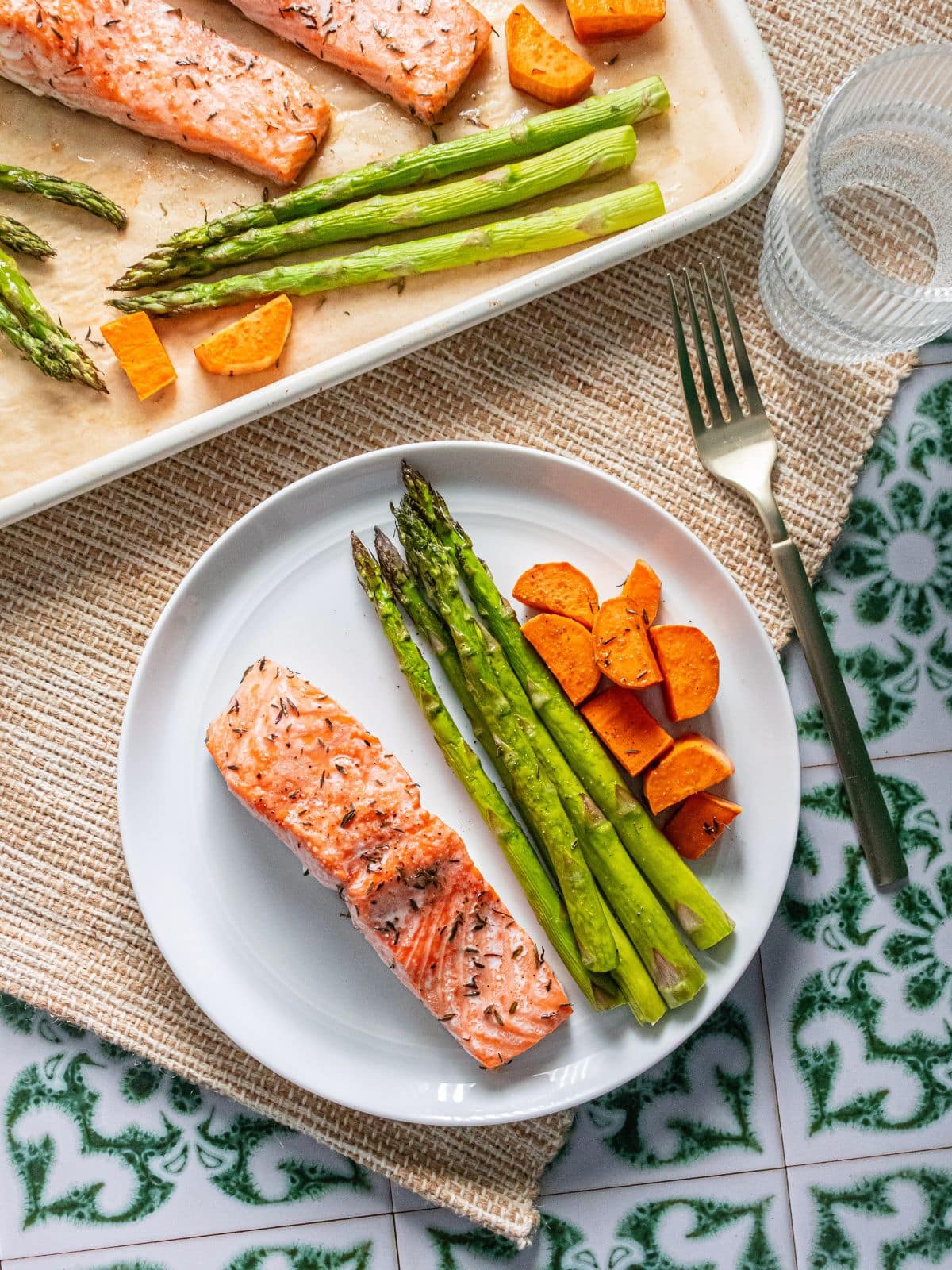 Sheet pan salmon on a plate with veggies.