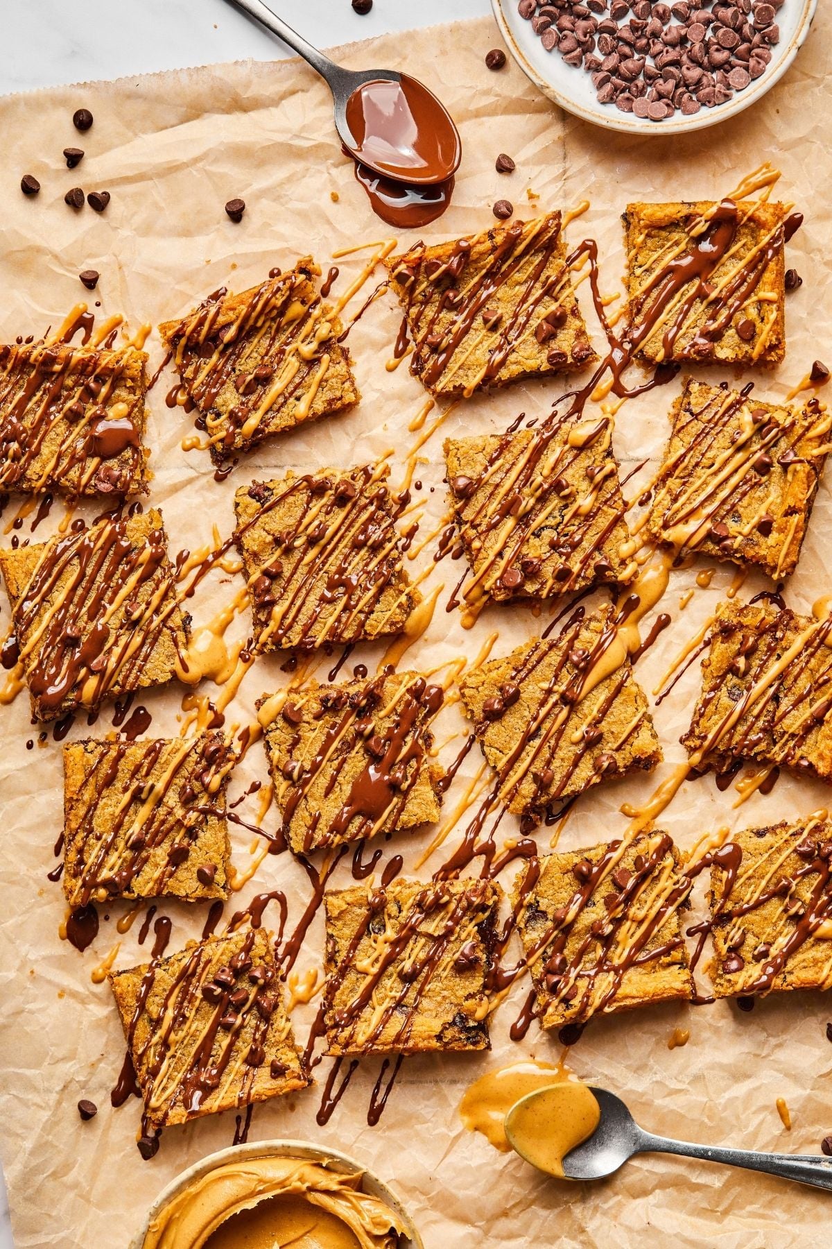 The cooked healthy blondies cut into pieces and toppings drizzled on top.