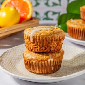 Gluten-free poppy seed muffins stacked on top of one another.