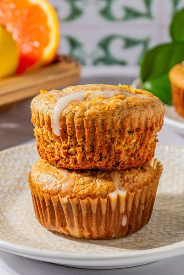 Gluten-free poppy seed muffins stacked on top of one another.