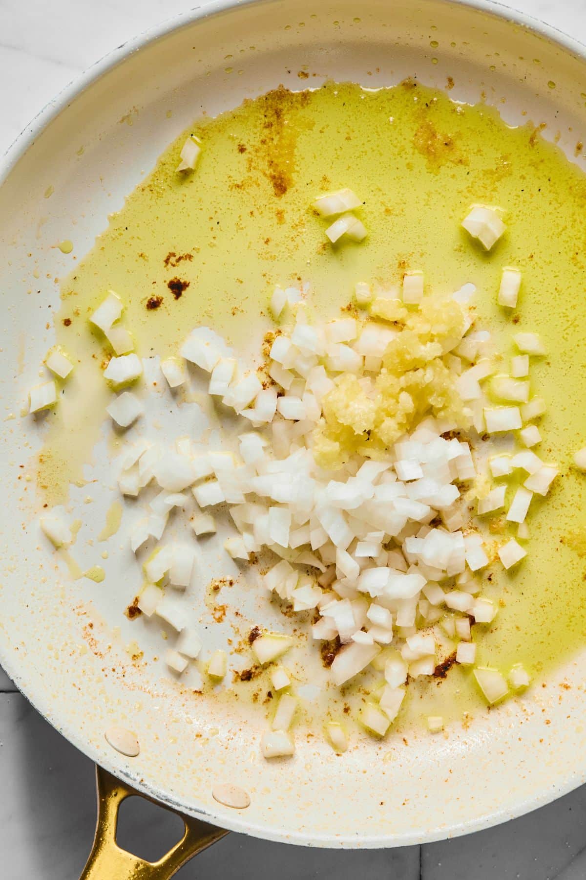 Onions and garlic into the skillet.