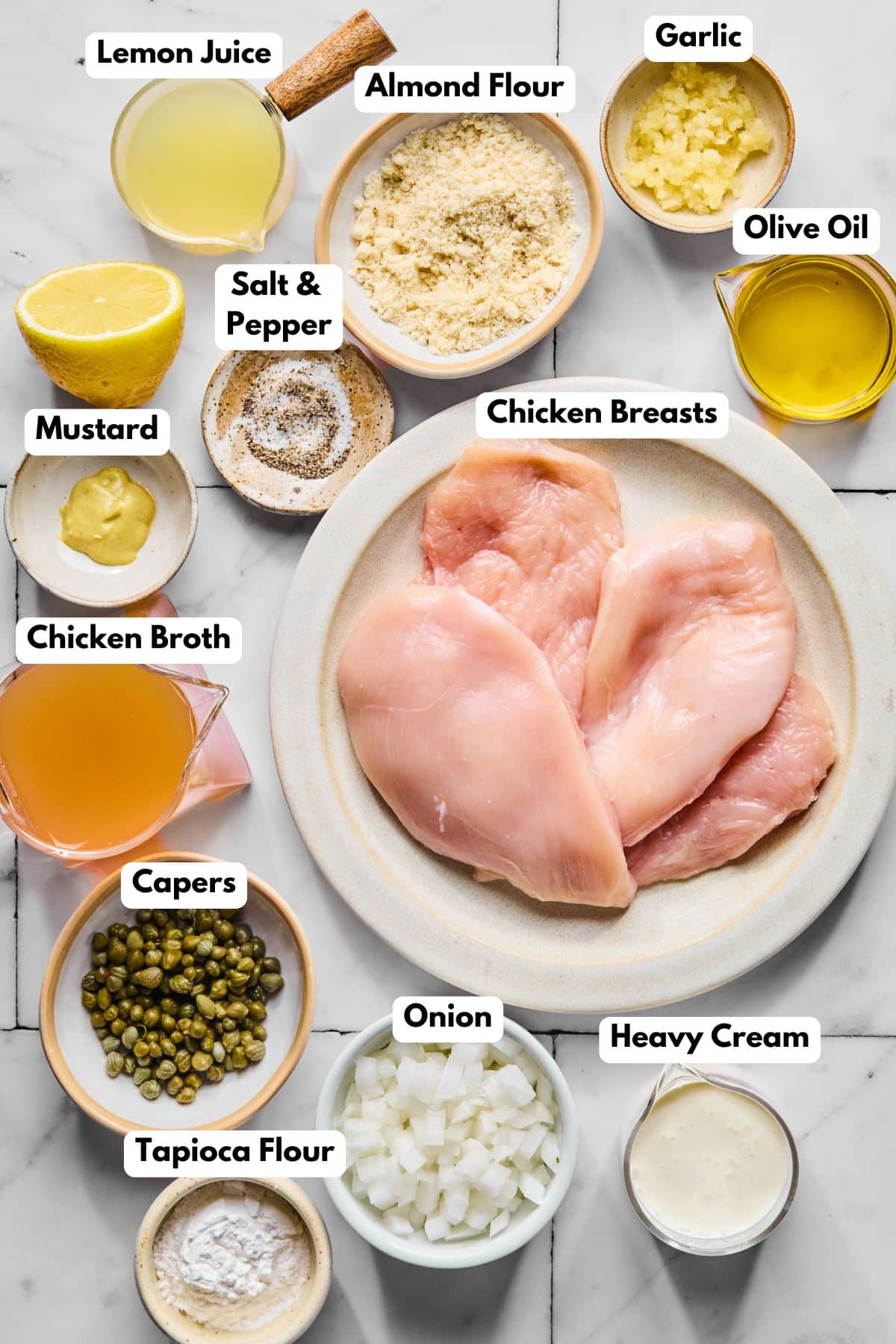 Ingredients to make this piccata in bowls on a table.