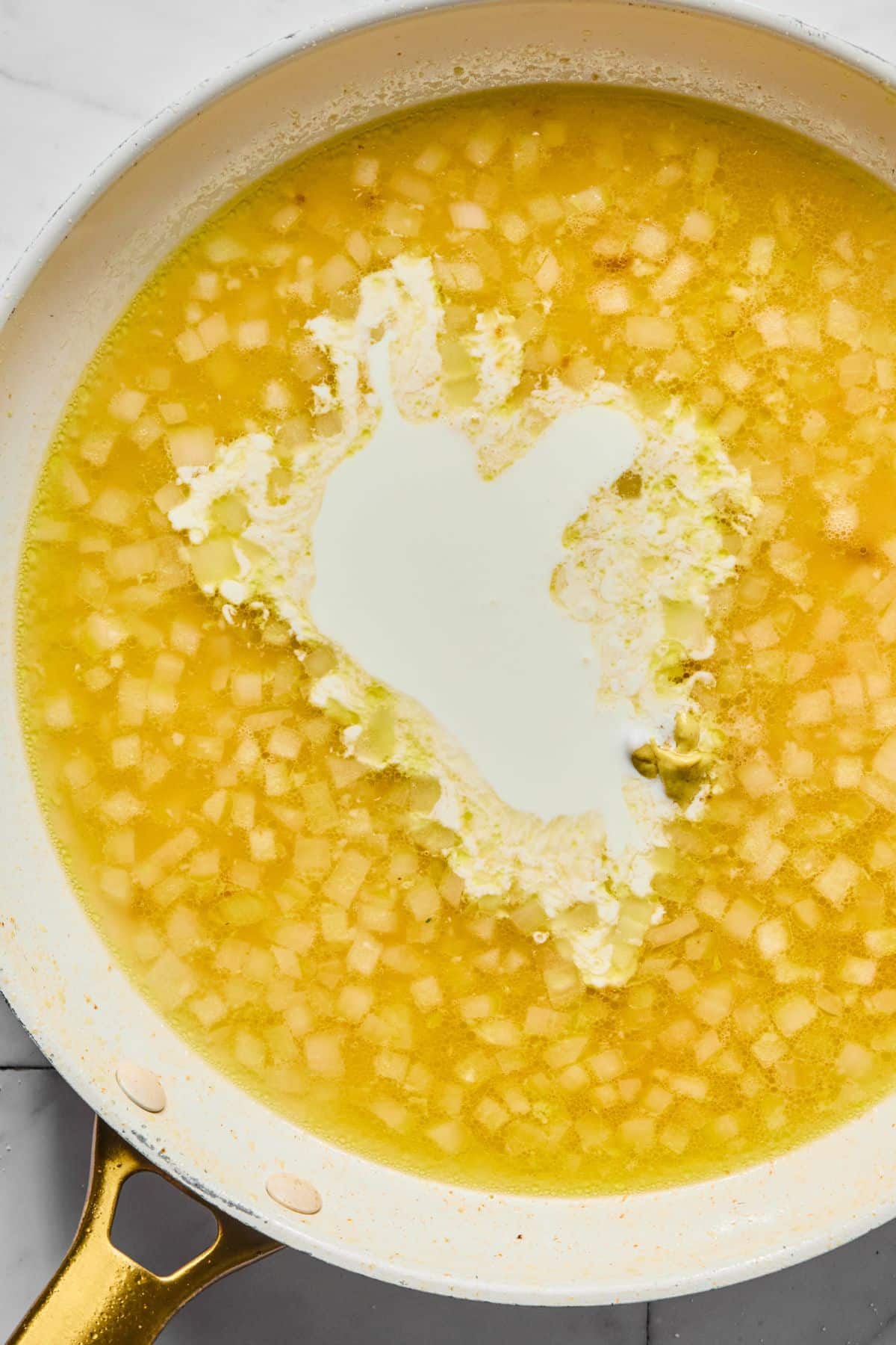 Cream added to the skillet.
