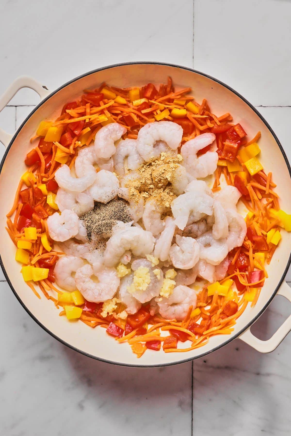 Garlic, shrimp and spices added to the veggies.