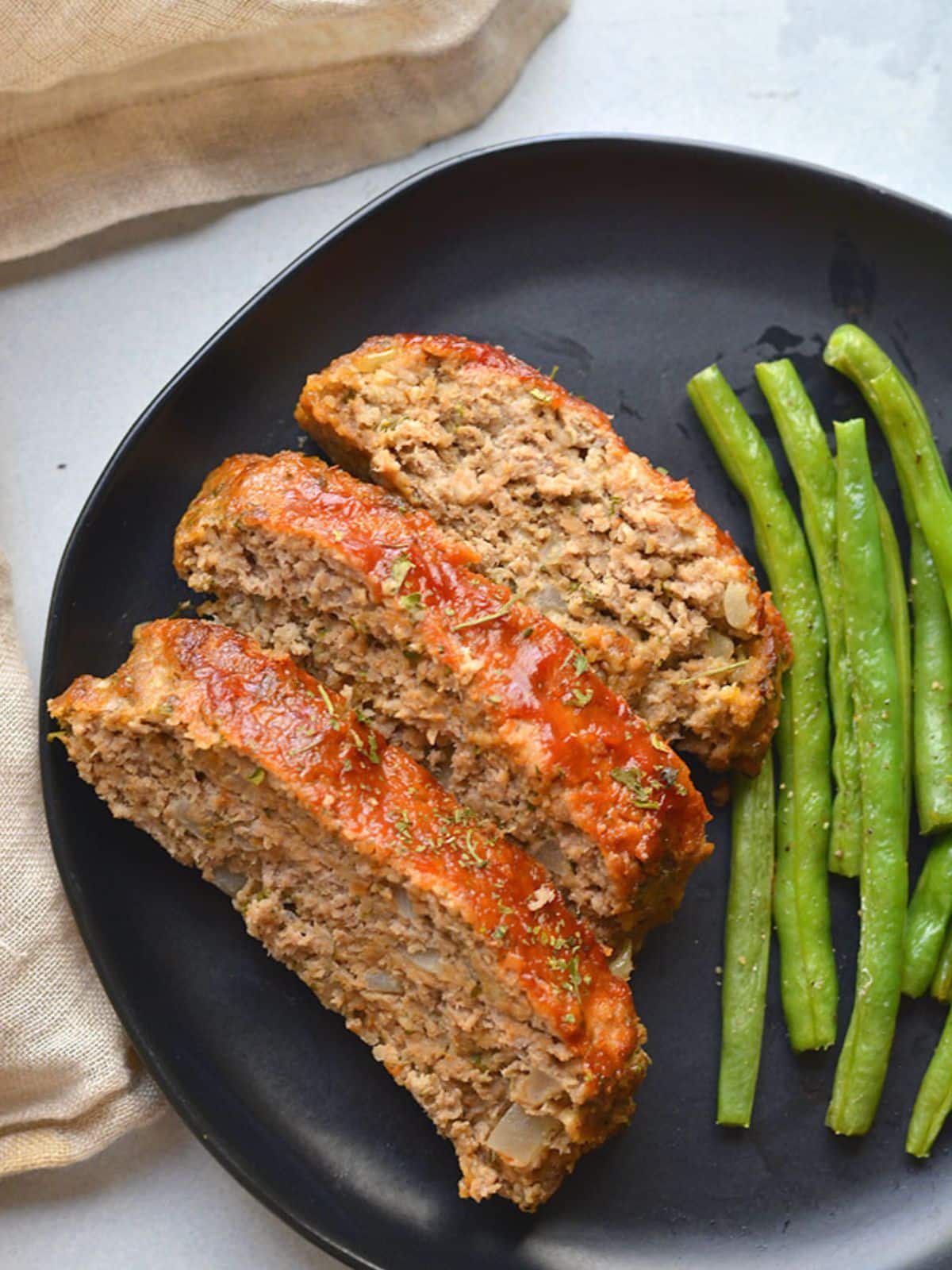 Slices of turkey meatloaf on a plate.