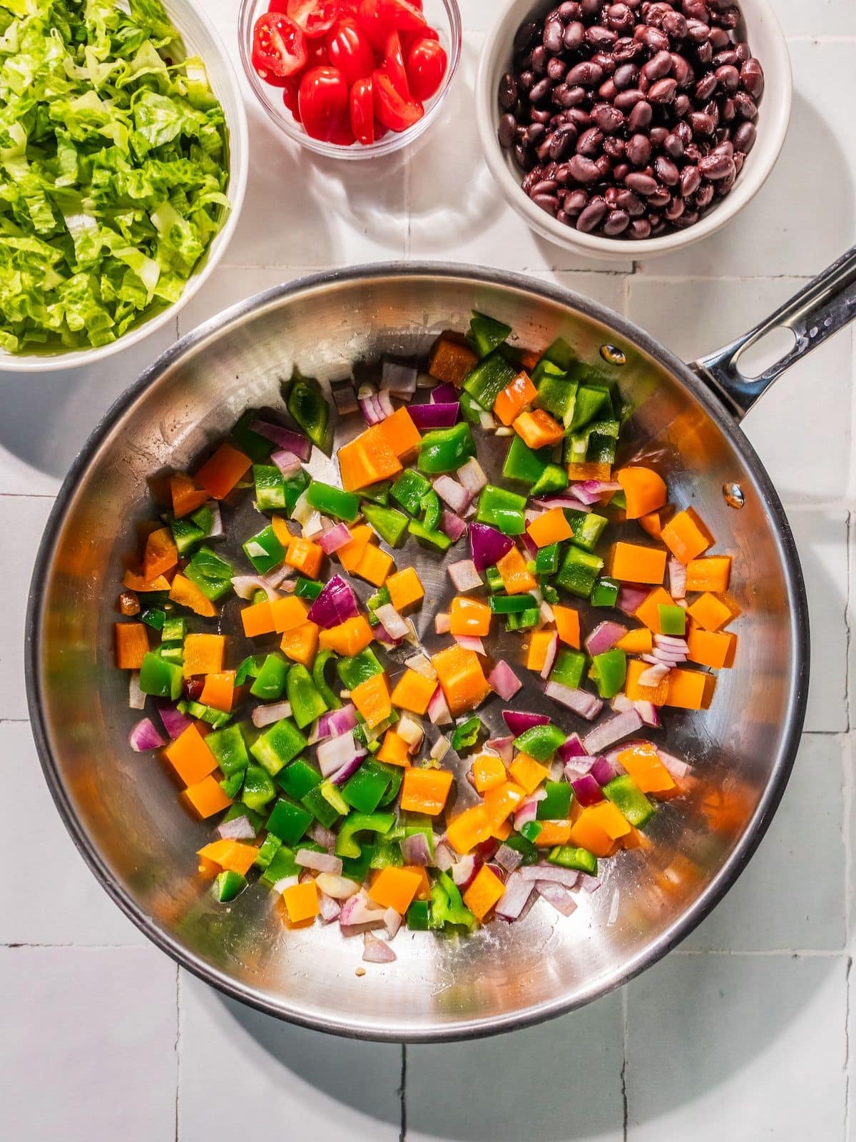 Bell peppers, red onion, and jalapeno in a skillet.