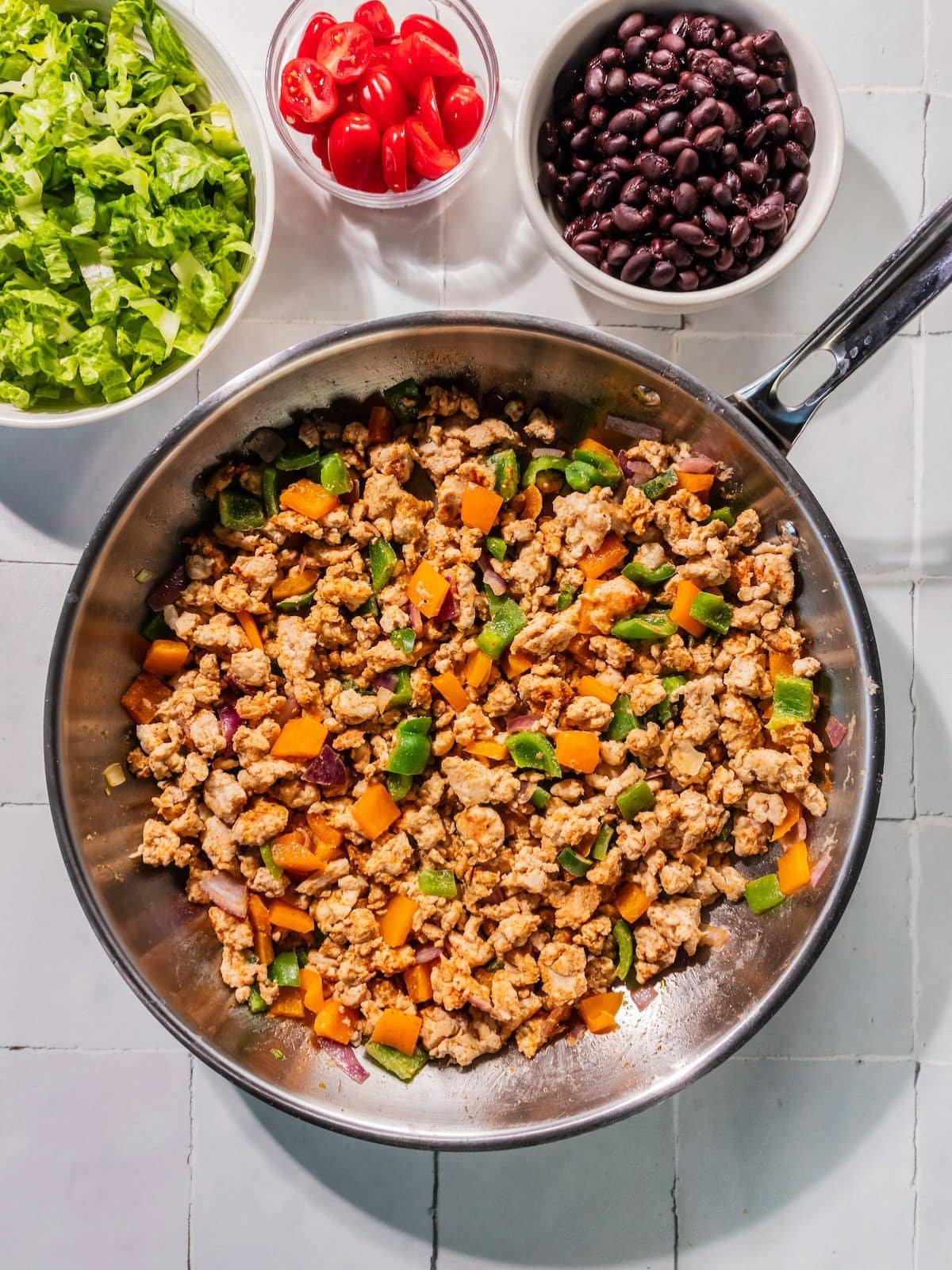 Ground turkey and seasonings added to the skillet.