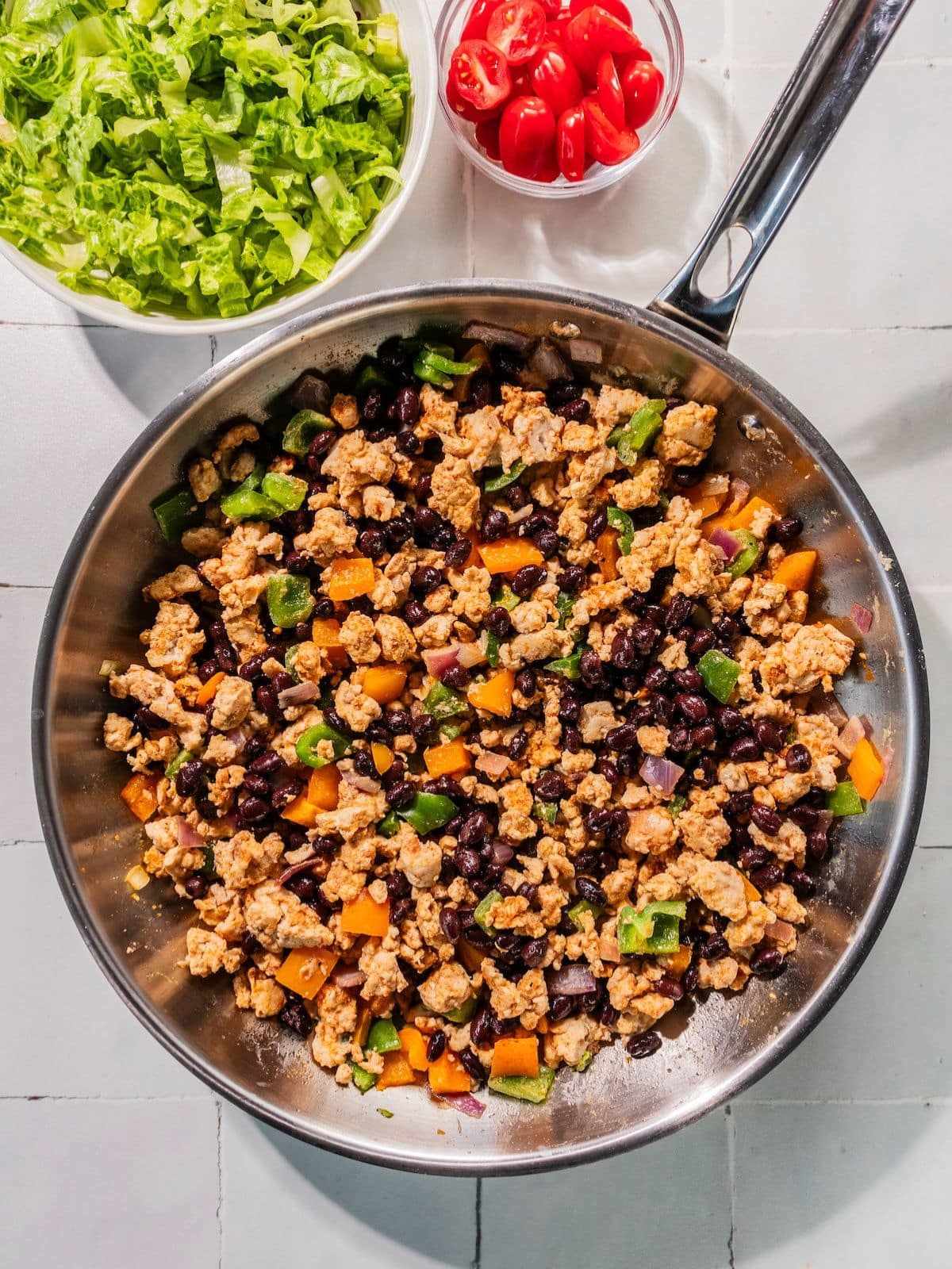 Black beans added to the skillet.
