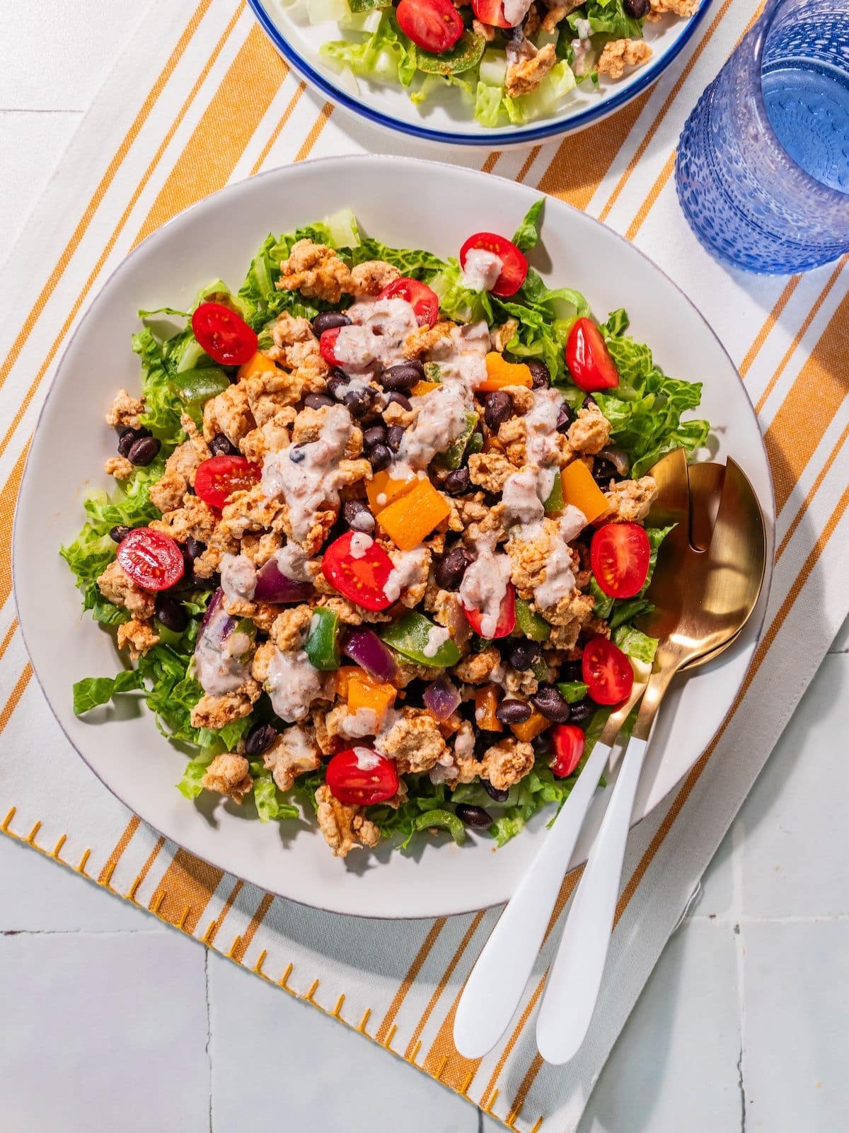 The low calorie taco salad assembled with the dressing on top.
