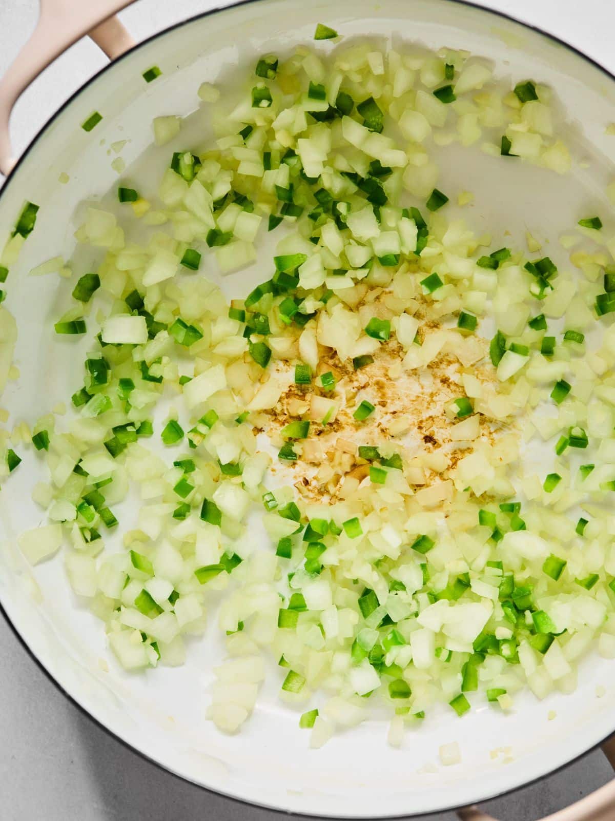 Garlic, onions, and peppers in a pan.
