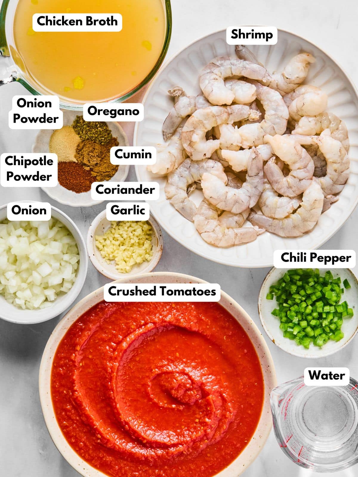 Ingredients to make this Mexican shrimp soup in bowls on a table.