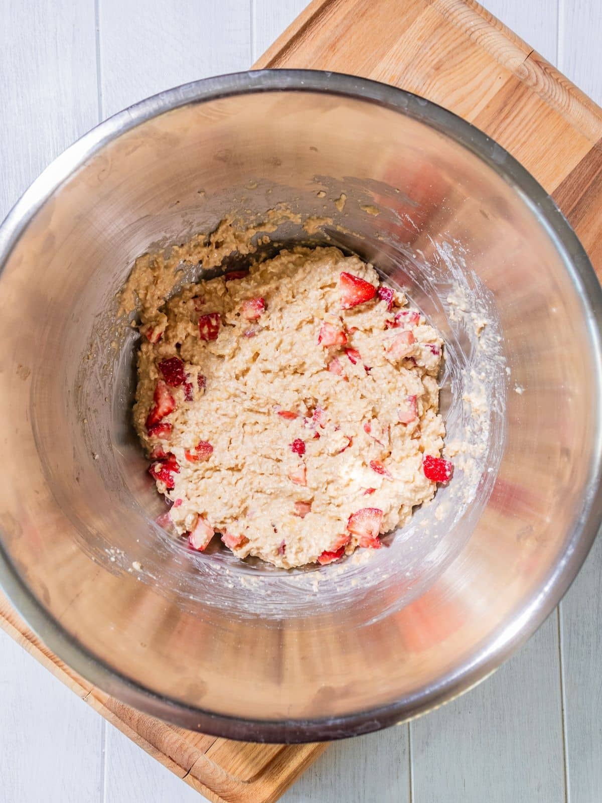 The dry ingredients added to the wet ingredients in a bowl.