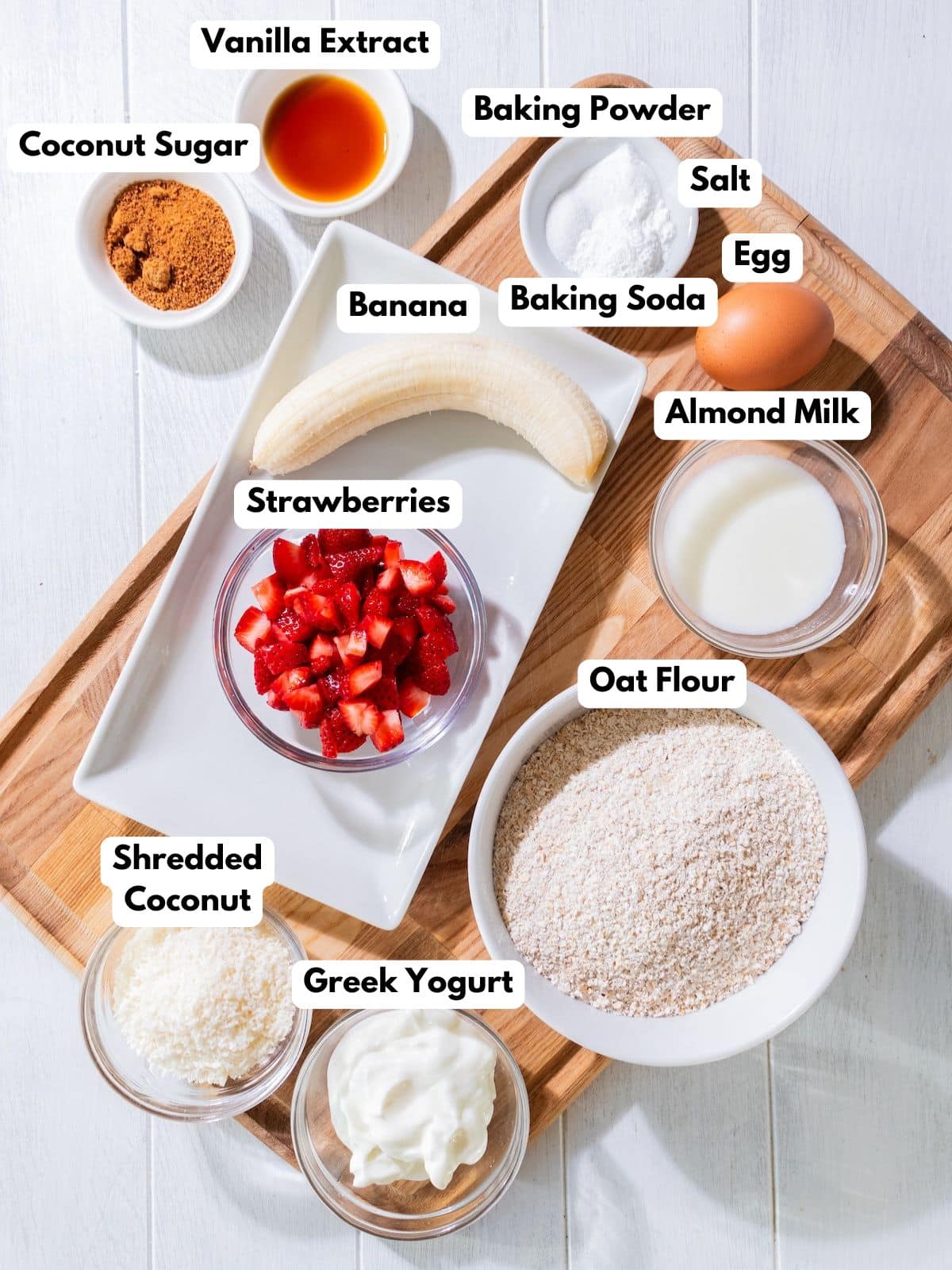 Ingredients to make this strawberry banana bread in bowls on a table.