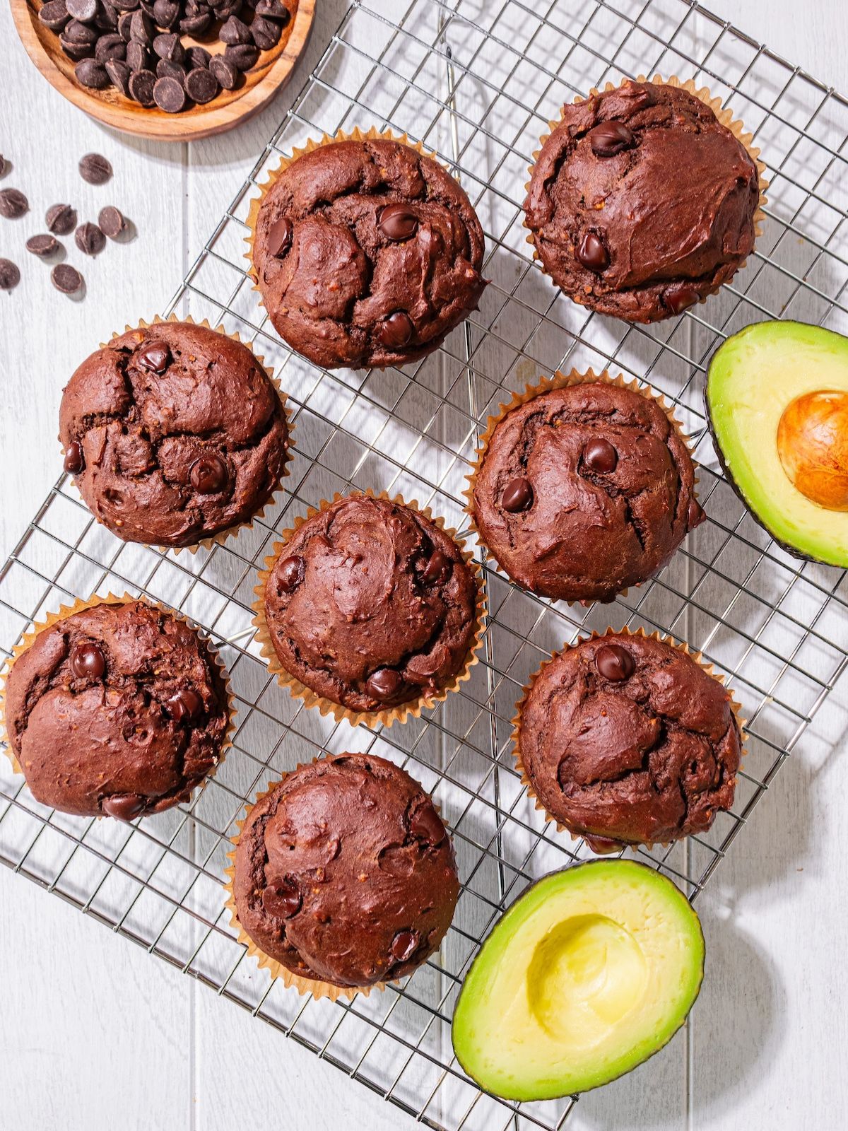 Chocolate avocado muffins on a cooling rack.