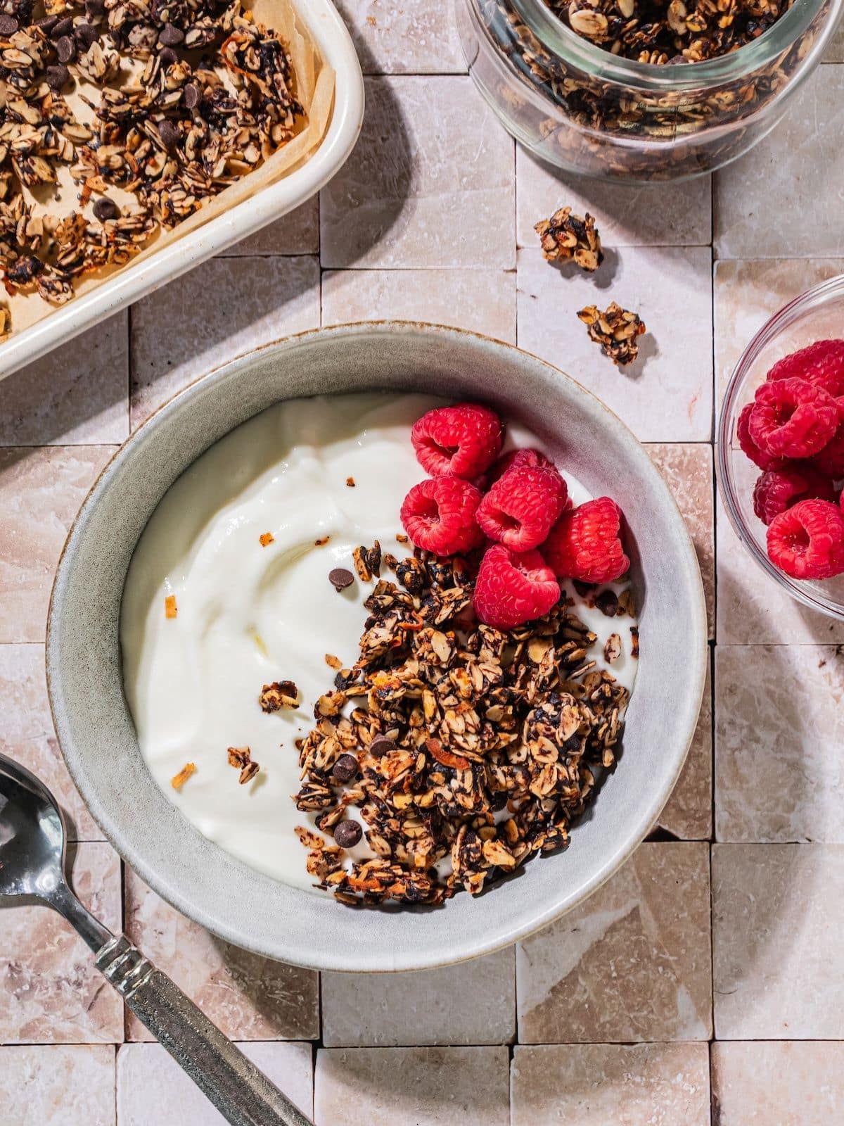 Chocolate granola over yogurt in a bowl.