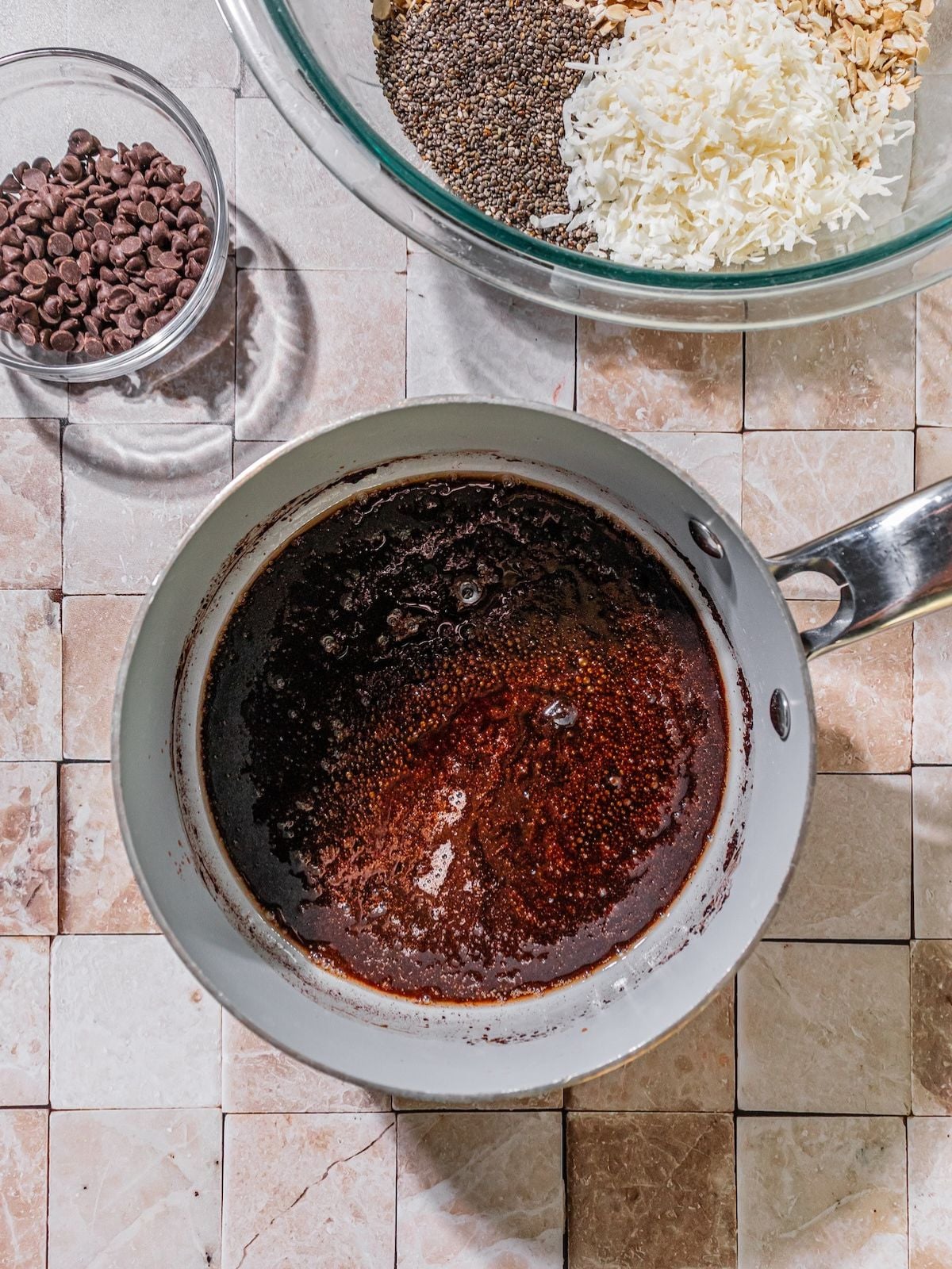 Coconut oil, almond extract, cocoa powder, salt, and maple syrup in a saucepan.