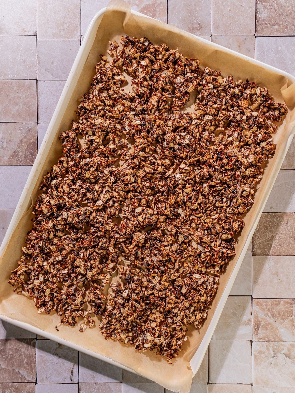 The granola transferred to a baking sheet.