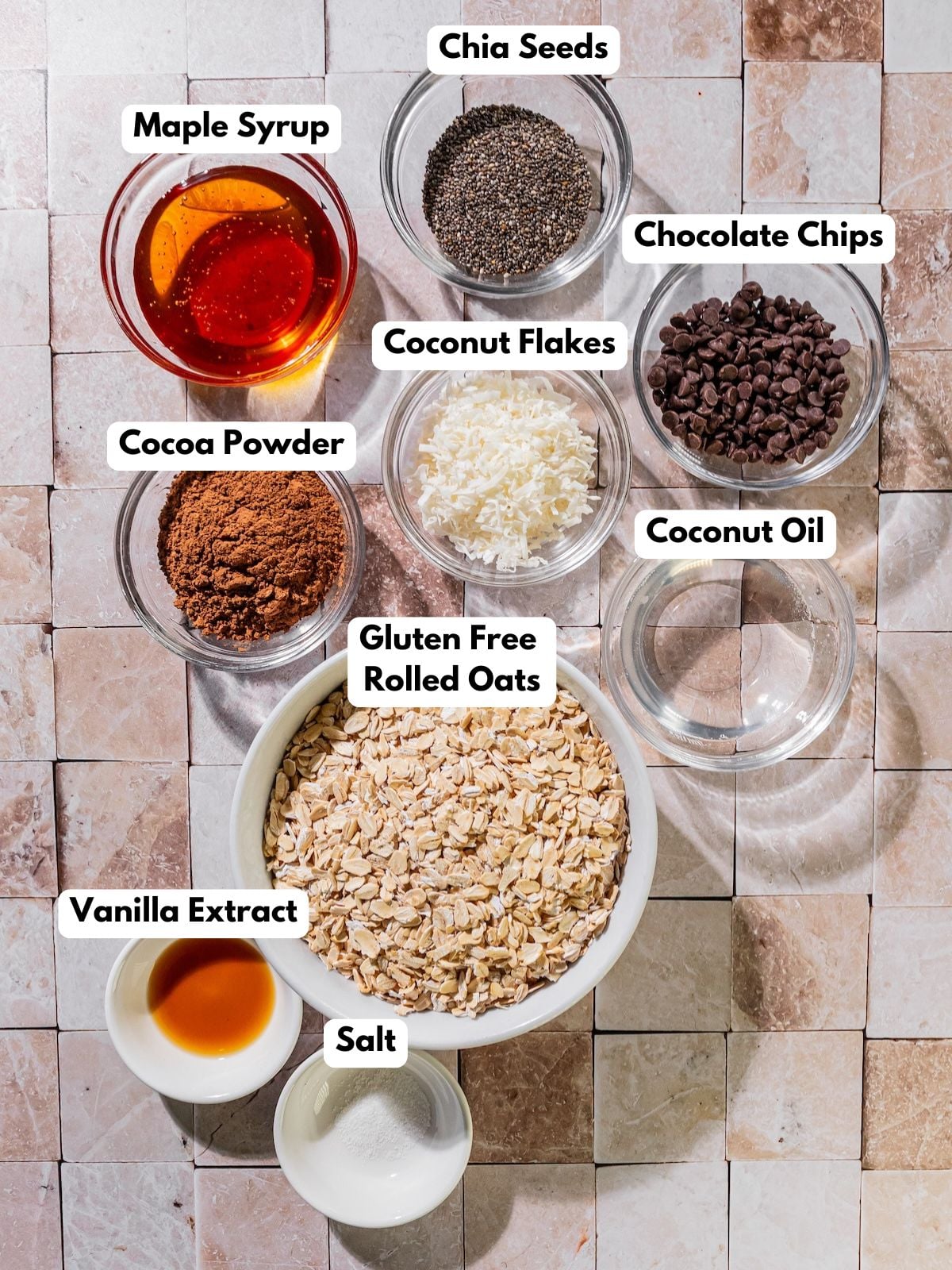 Ingredients to make this granola in bowls on a table.